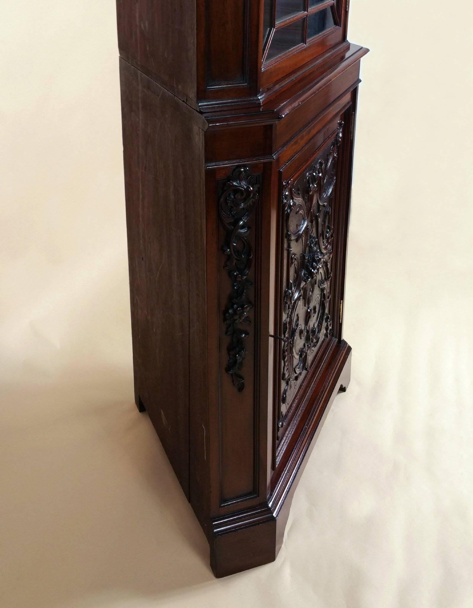This superb quality and very striking late 19th century mahogany Chippendale style corner cabinet was made by Edwards & Roberts, who were well-known cabinet makers of the period. The firm Edwards and Roberts were among the best English antique