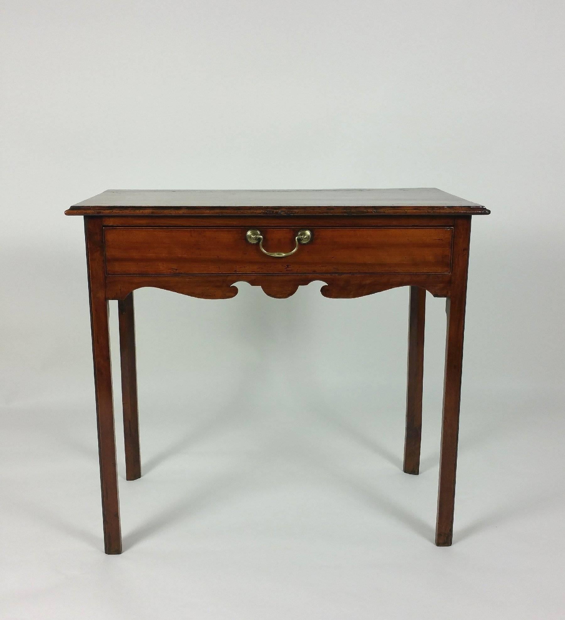 This charming 18th century fruitwood single drawer lowboy features the original brass handle and stands on chamfered square supports. It measures 33 1/4 wide, 18 3/4 in deep and 30 in height.