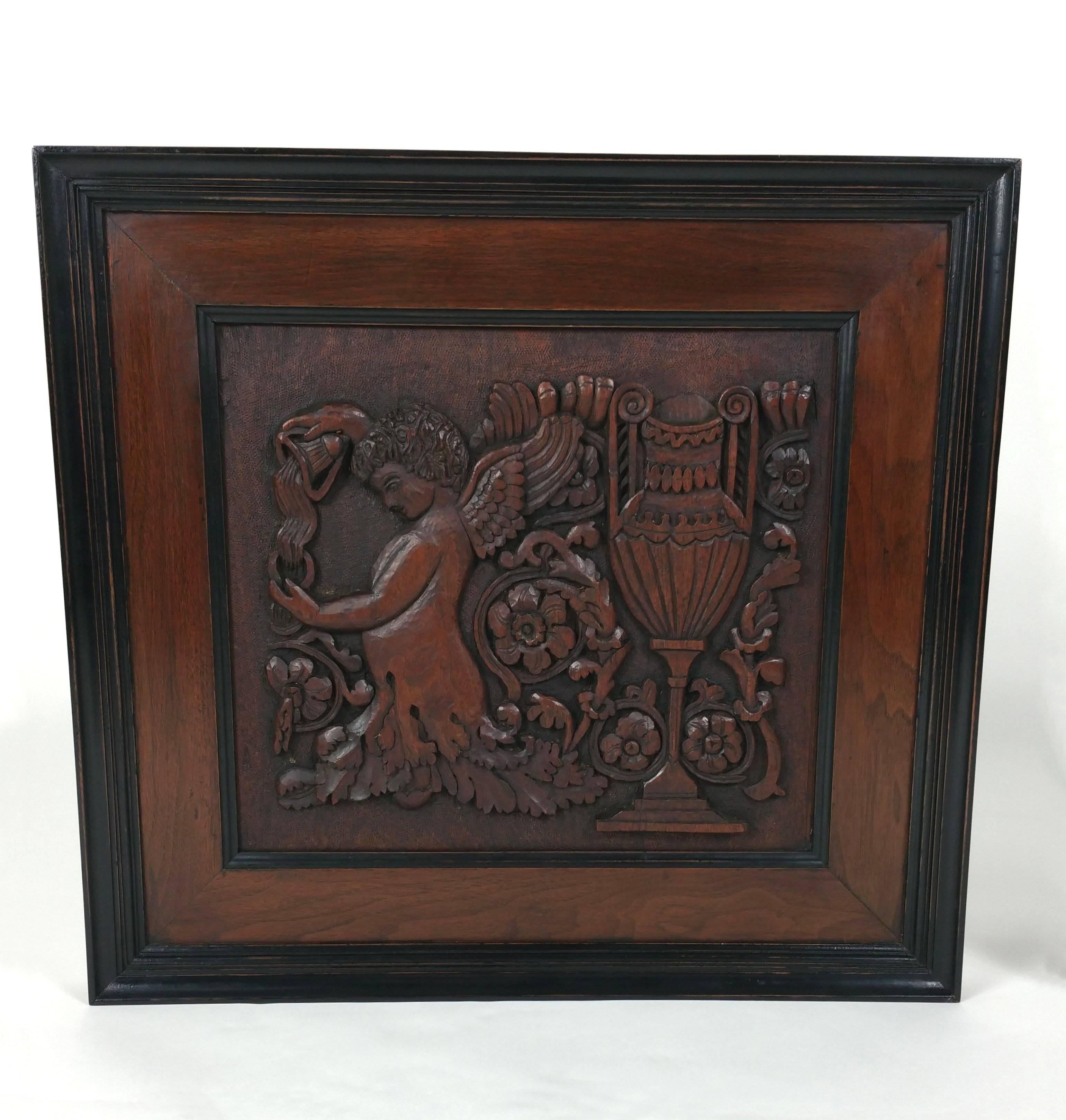 This lovely pair of 19th century carved walnut framed panels depicts classical urns and winged cherubs pouring from vessels, against a background of ferns and flowers. It bears a label on the back inscribed ‘This was carved by my mother, Eleanor