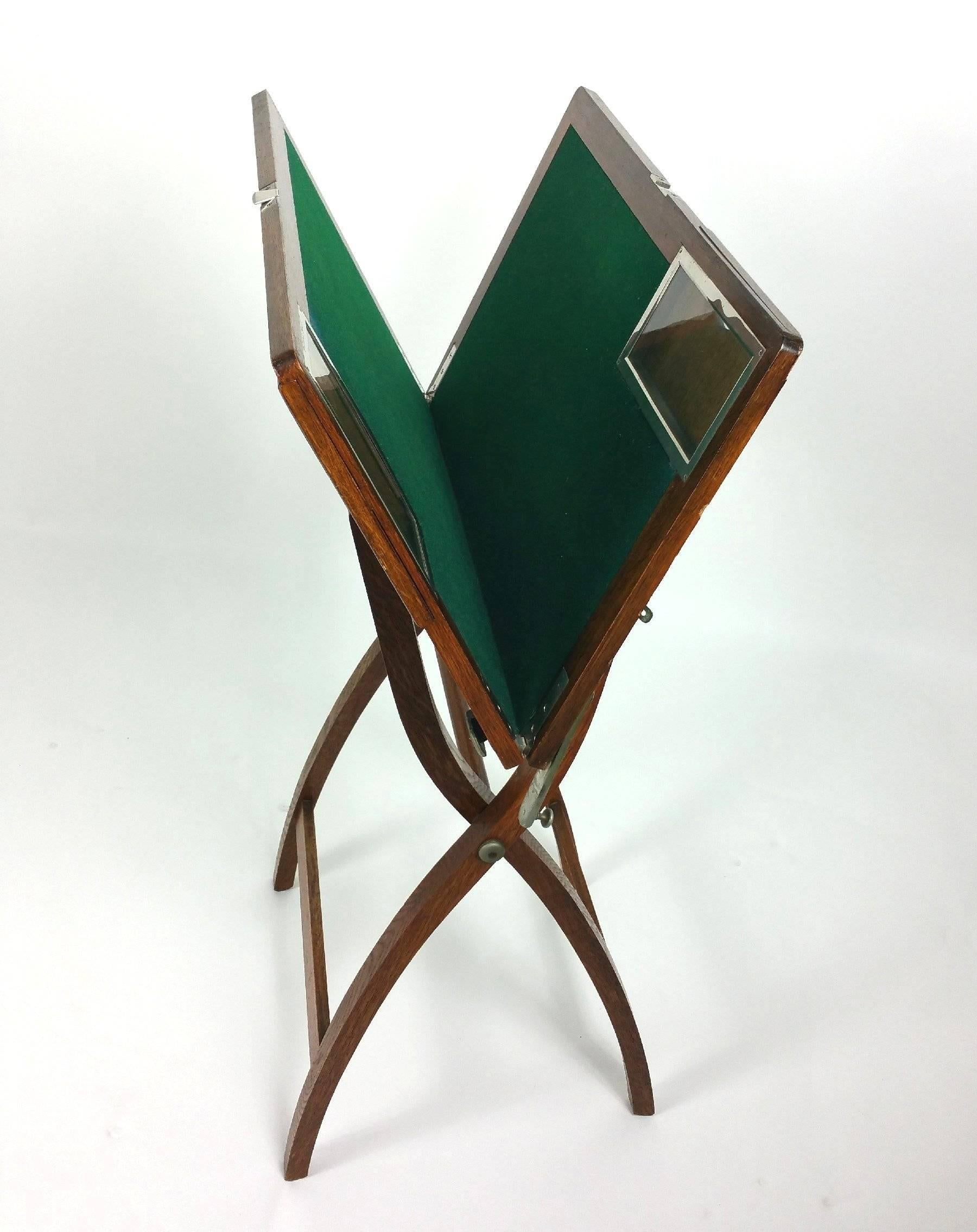 This gorgeous and well-designed Edwardian oak and chrome folding games table is by Asprey, an iconic British luxury brand. The table features two chrome and glass covered sliding compartments and a brass plate with the Asprey label. The green baize