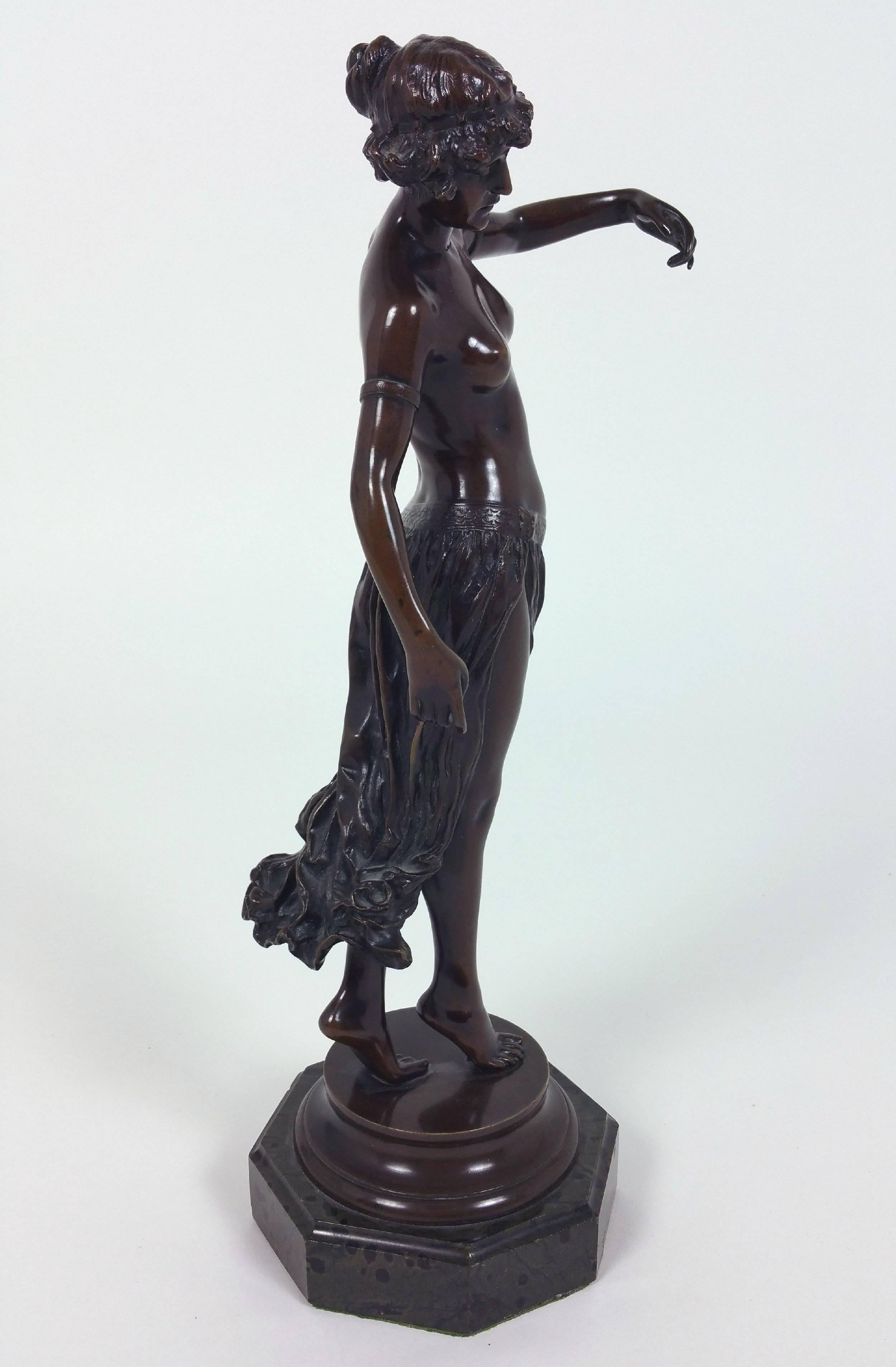 This angelic and gracefully poised bronze figure was done by Edward Onslow Ford, and is signed Onslow Ford on the plinth. This fine patinated bronze depicts a semi naked dancer, standing on a circular bronze plinth and mounted on an octagonal marble