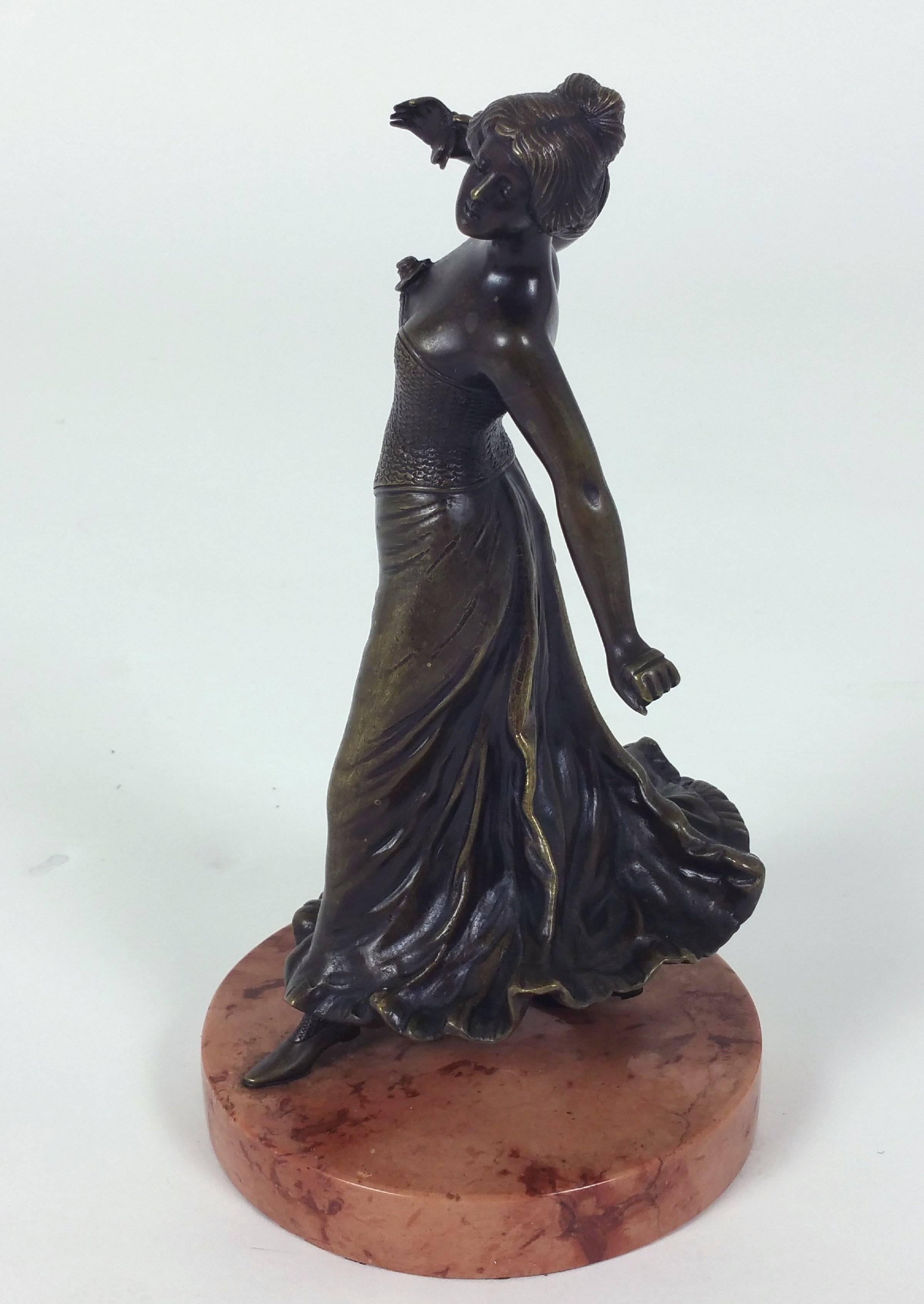 This beautiful and graceful 19th century, Spanish bronze is a figure of a female flamenco dancer. The sculpture stands on a circular shaped marble base and is also marked and monogrammed indistinctly on the bottom of her skirt. It measures 4 ¾ in –