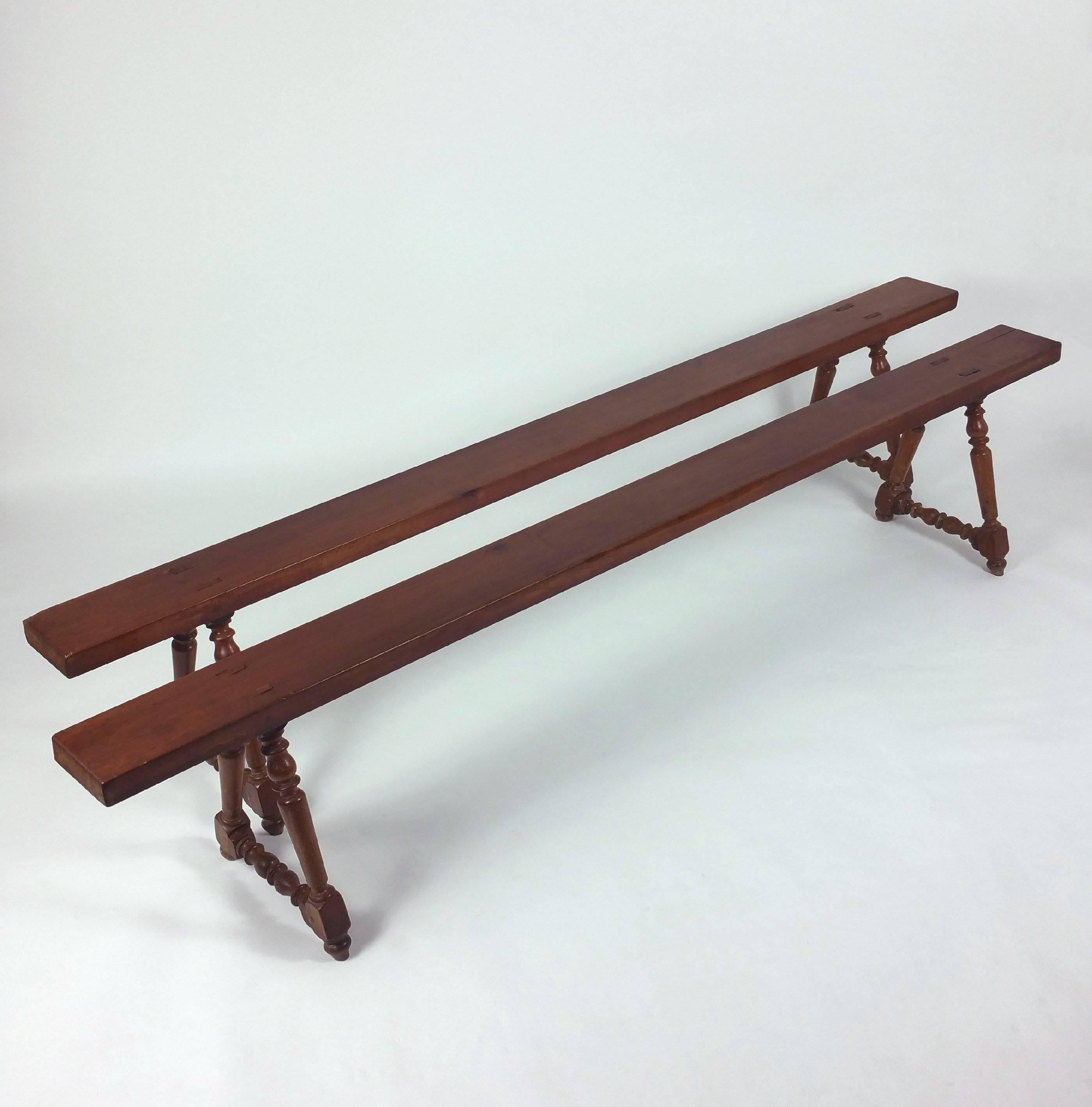 This gorgeous pair of 19th century French cherrywood benches on turned supports features a warm and rich patina in a simple but universal style. Each bench measures 6 ¼ in – 15.9 cm wide, 17 ½ in – 44.5 cm high and 90 ½ in – 230 cm in total length.