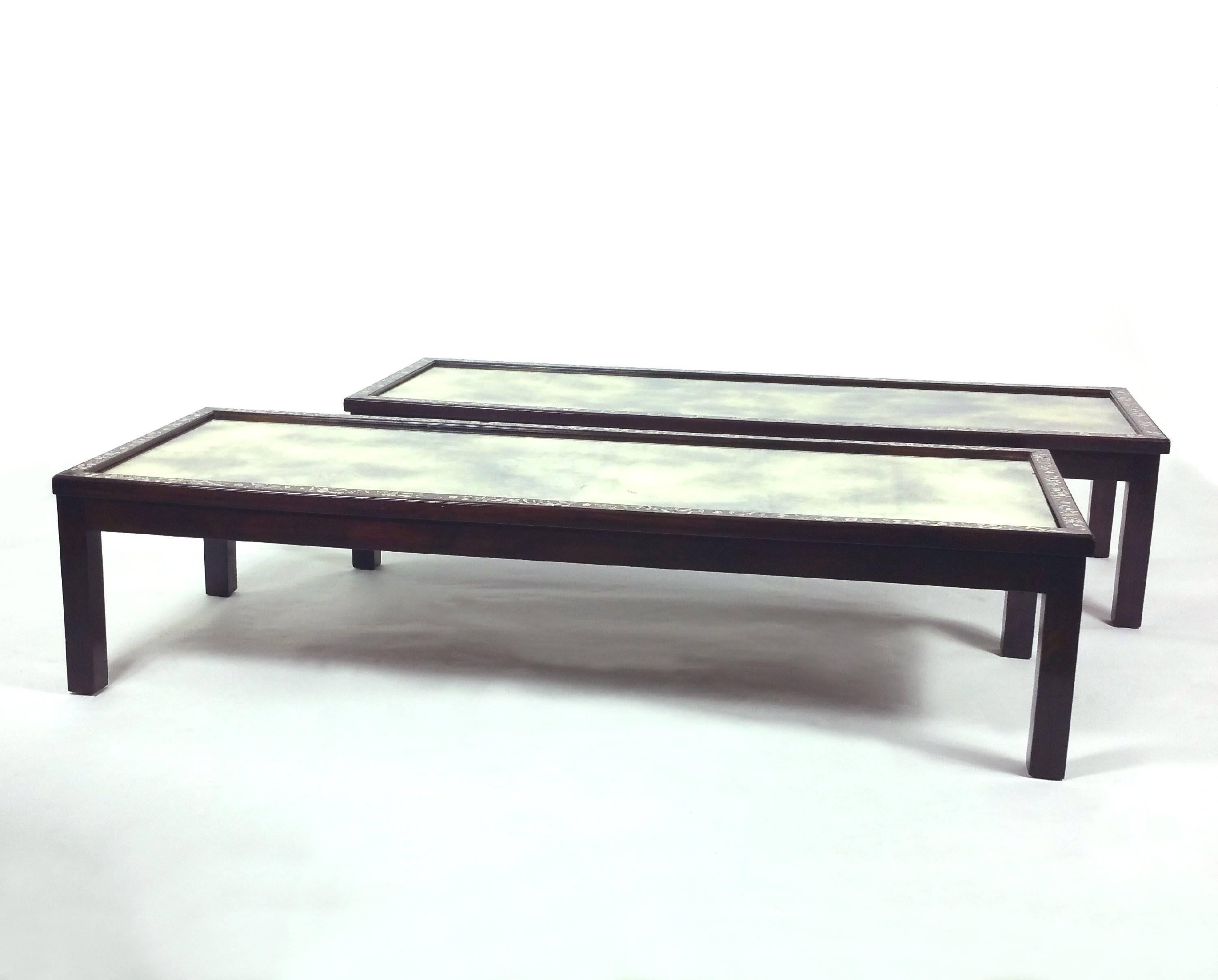 This fine pair of 19th century Chinese coffee tables were converted from two mirrored panels with inlaid mother-of-pearl frames. Each table measures 57 in – 144.8 cm long, 21 3.4 in – 55.2 cm deep and 13 ½ in – 34.3 cm in height. They would make a