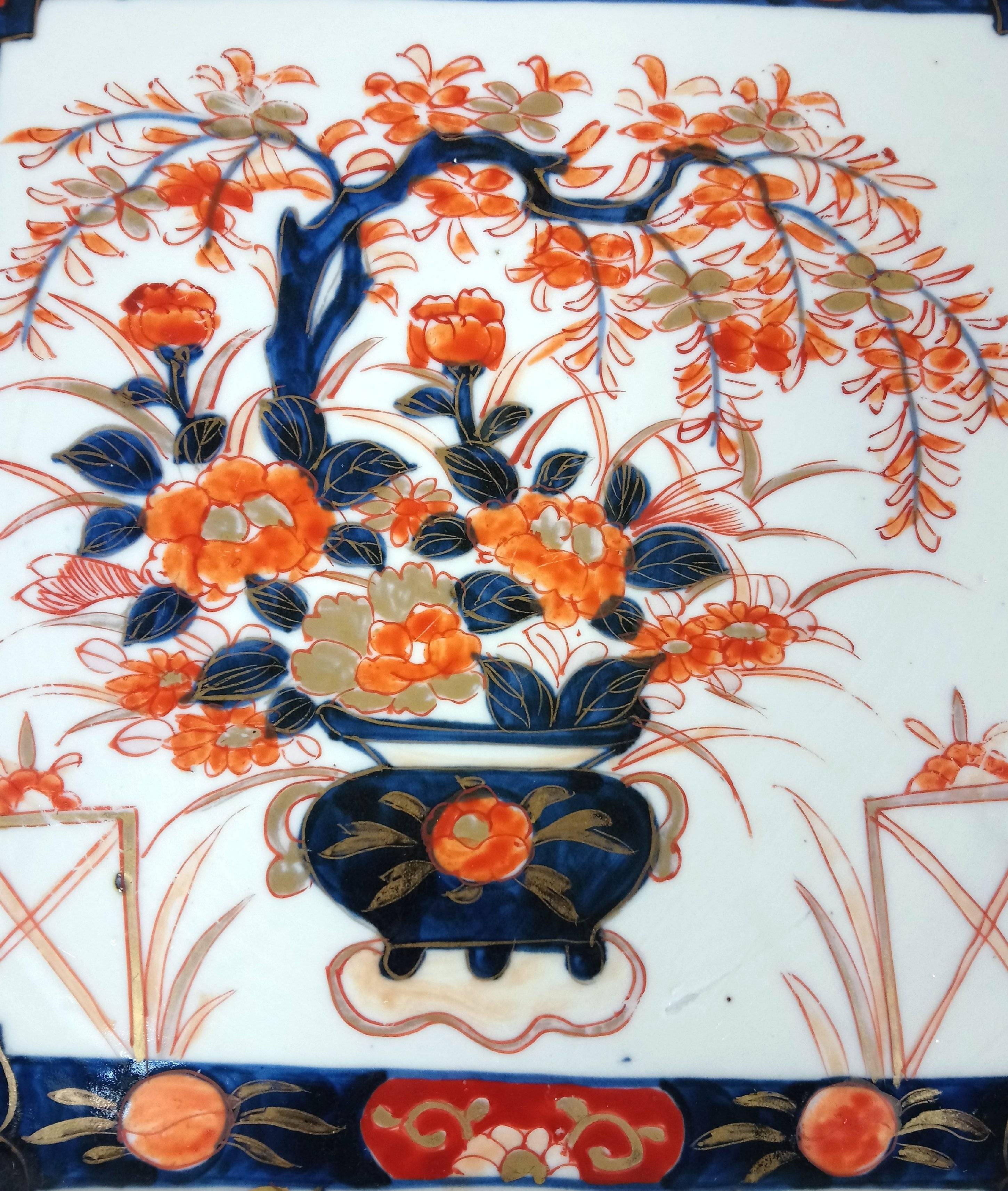This very attractive and well-proportioned size 19th century. Japanese Meiji period Square platter features a central portrait of a blooming Jardinière of flowers with a trellis border of blooms and birds in the traditional deep blue and orange