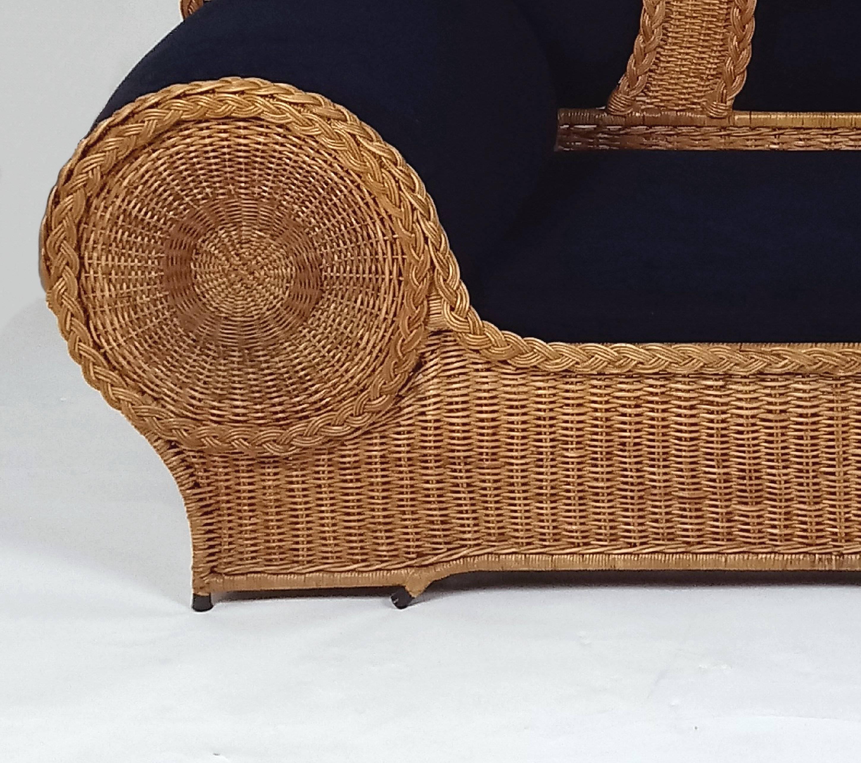 This gorgeous mid-20th Century wicker sofa is from the well-known brand Biba, upholstered in black velvet corduroy. The sofa has a sound and sturdy metal base frame and aside from several very small frays of the wicker, is in amazing condition for