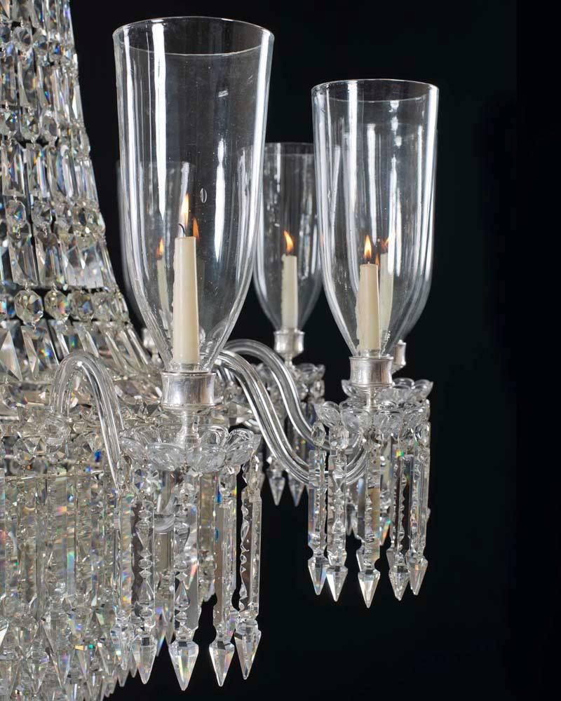 A fine victorian cut-glass chandeliers of Classic tent and waterfall design the frames supporting twelve candle arms these with drop hung drip pans and hurricane storm shades. The chandeliers hung with eight sided spangles, cut back Alberts and