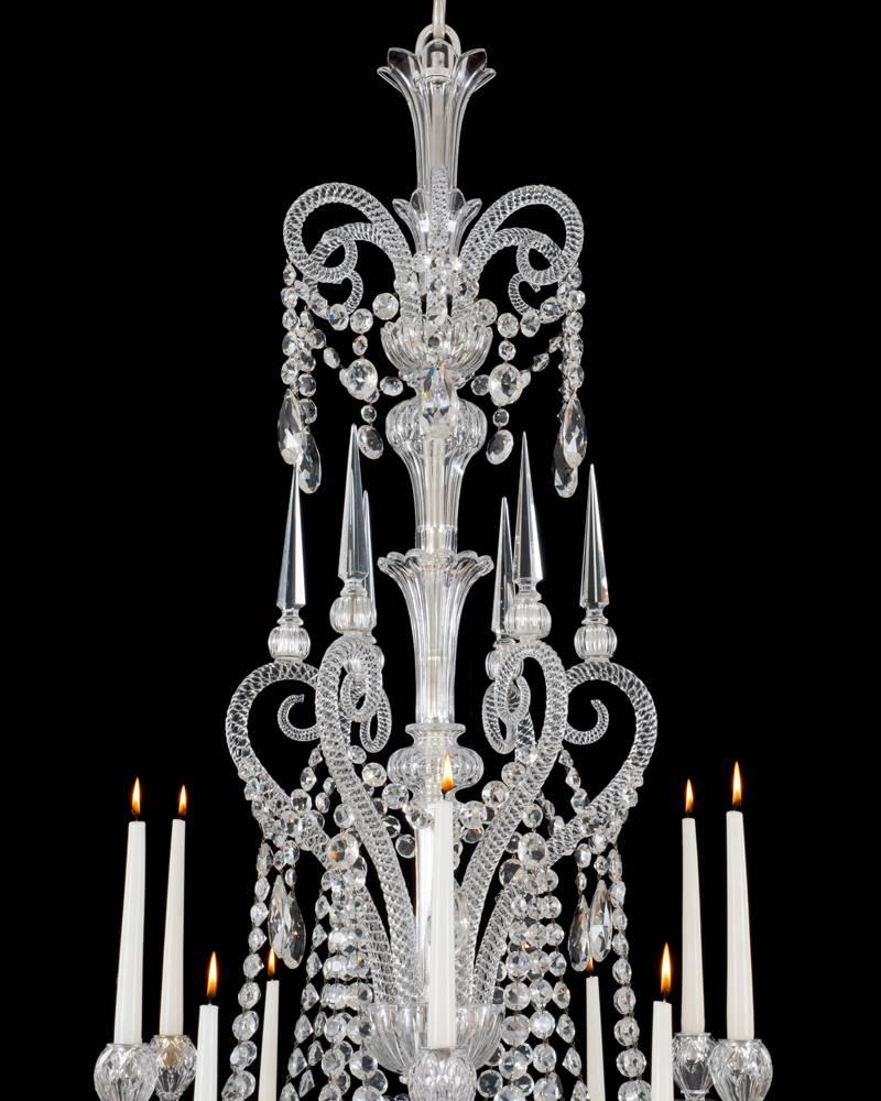 An important cut-glass twelve-light chandeliers by F&C Osler.
The flute and slice cut baluster stem centred by six rope twisted reversed crooks these terminating with thumb cut collars and six sided spires the crooks also supporting swags of