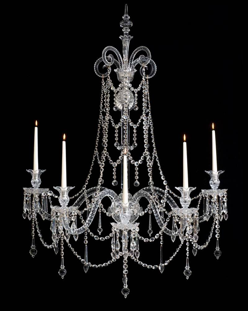 An extremely rare early Victorian set of four five-light cut-glass silvered mounted wall-lights of exceptional quality the central slice cut shaft surmounted by unusual cross over diamond cut balls and glass covered fixing plates the upper ball