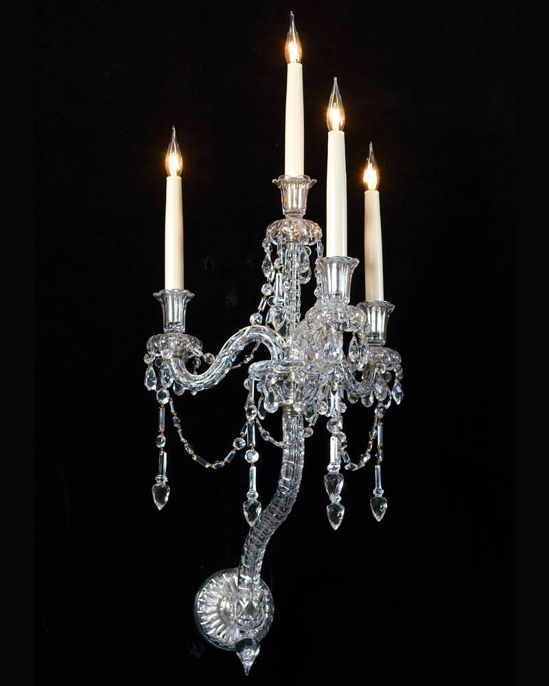 An unusual pair of four-light mid Victorian silvered mounted, cut-glass wall- light by F&C Osler the arm plate supporting three s shaped thumb cut candle arms these arms centred by a thumb cut column which is surmounted by the forth light the candle