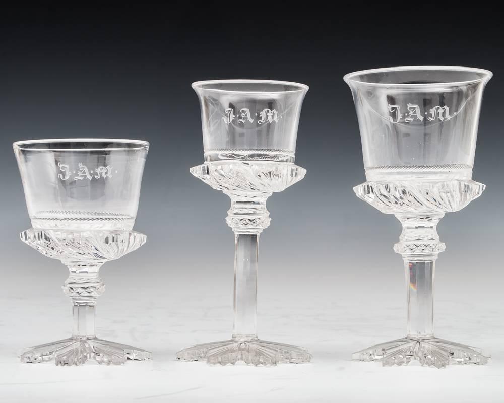 The fine suite of glasses cut with eight point star foot slice cut stem with diamond cut knop this supporting a flared bucket bowl with deep spiral cutting at the base engraved with rope band and the initials J.A.M.
The service consisting of 12