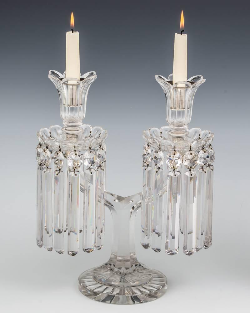 A fine pair of Victorian candelabra by F&C Osler with star cut base supporting twin glass branch issuing drop hung drip pans and candle nozzles.