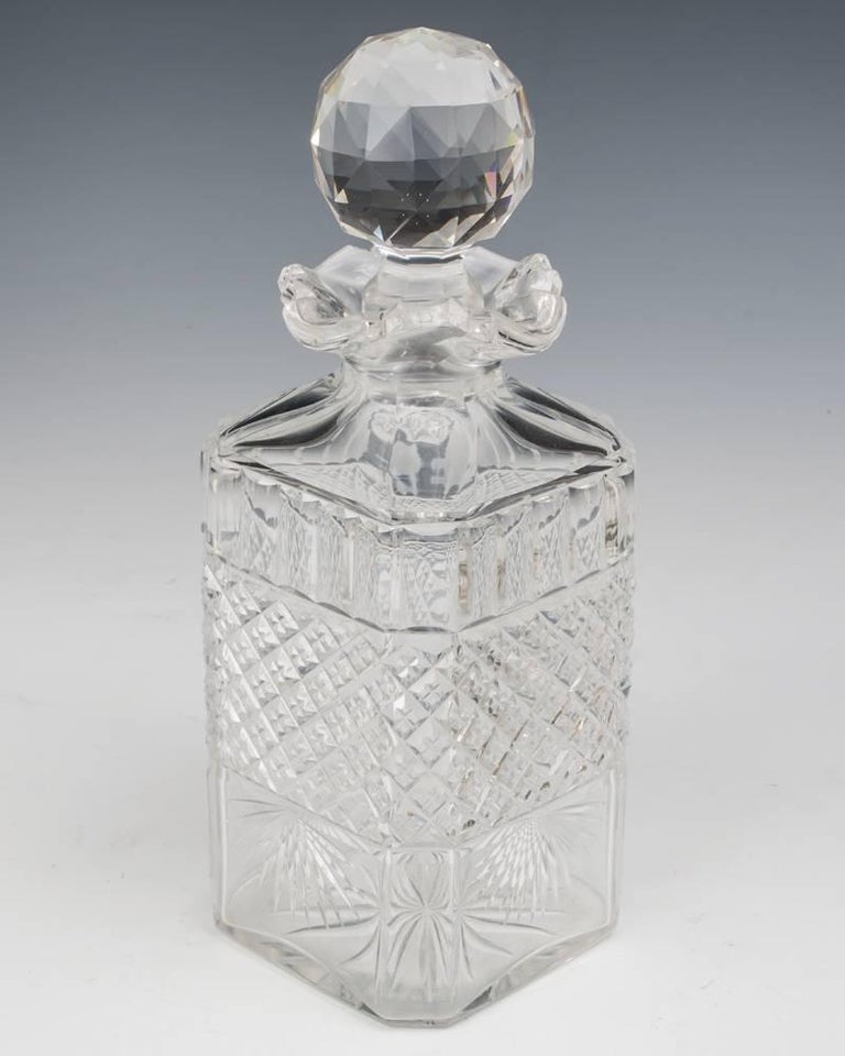 A fine silver plate decanter tantalus with fine englaveing on both sides holding three elaborately cut decanters with most unusual four pour necks.
