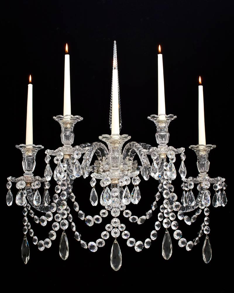 An important pair of English mid-Victorian five light cut-glass and silvered mounted wall lights the silvered ring surmounted by flower rosettes, five thumb cut candle arms with thistle shaped candle nozzles and drip pans arranged on two levels