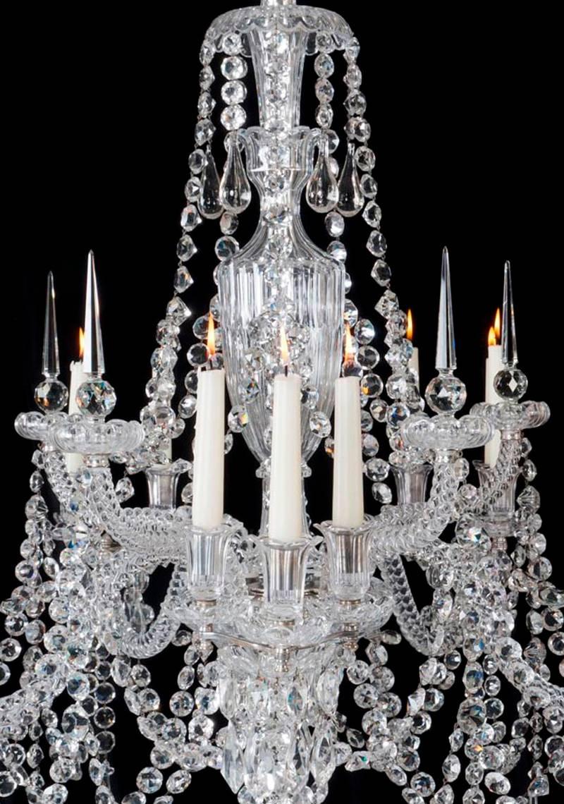 A fine quality cut glass fifteen-light chandelier by F&C Osler the main baluster shaped shaft surmounted by a drop hung canopy and a draping pan with cascading drapery terminating at the back of the drip pans. The main flute cut receiver bowl with