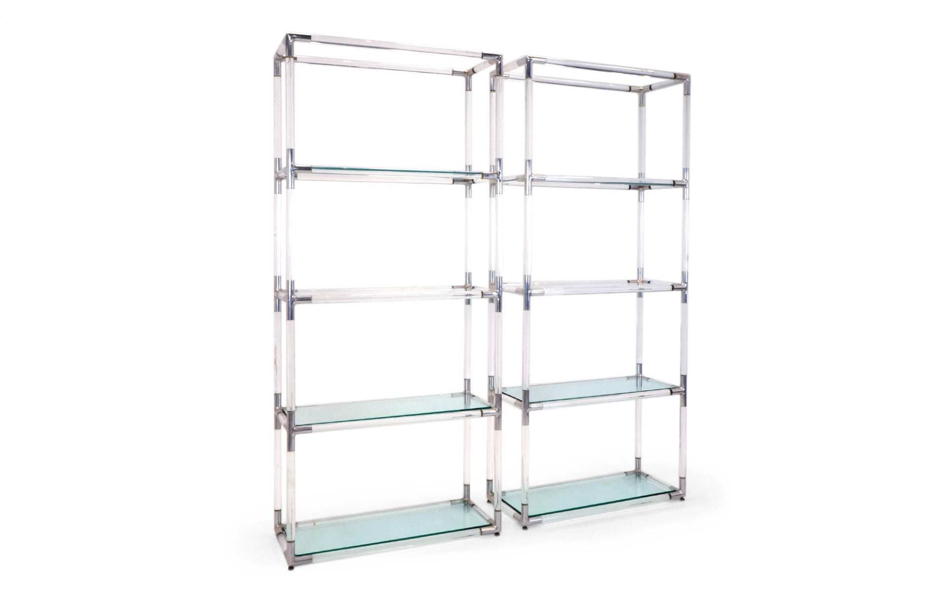 Pair tubular of Lucite storage shelf systems with polished aluminium joinery and glass shelves. The two lowest shelves are 1/2 glass to add bottom weight and the rest of the shelves are 3/8
