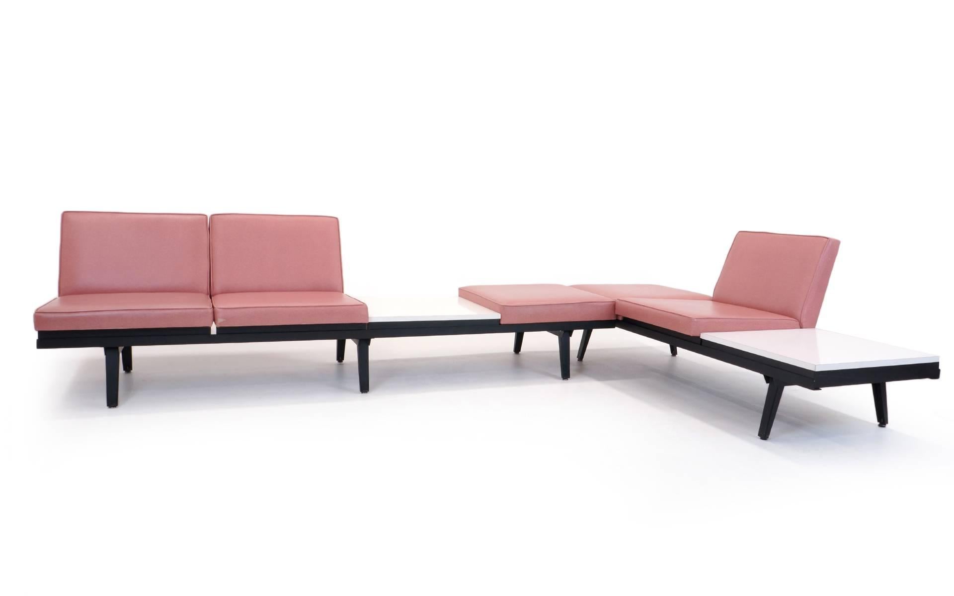 Two George Nelson steel frame sofa / seating units. One is four sections (8 feet long) and the other is three (6 feet long). All of the seats and tables are interchangeable so the options for set up are too many to calculate. The frames are in