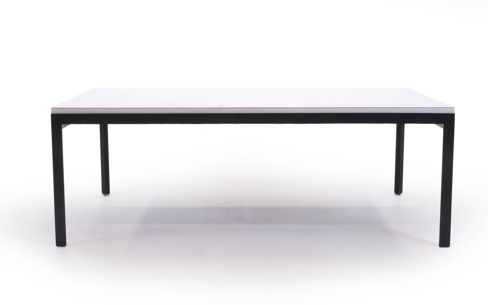 Signed Florence Knoll cocktail table. Original white laminate and lacquered steel legs and frame. Very heavy duty construction and super durable.