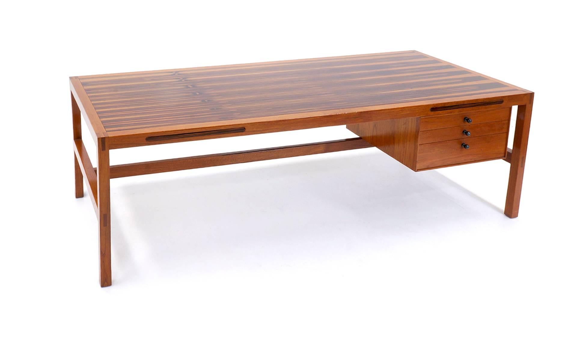 Stunning 8 ft. by 3 ft. desk/work station featuring two 14-inch, pull-out work surfaces and three locking drawers with key.