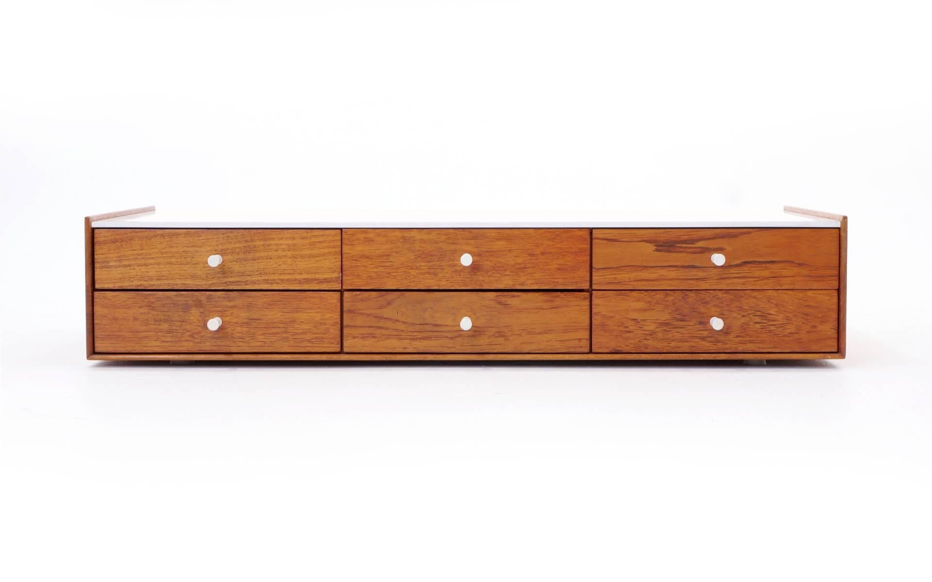 Early George Nelson for Herman Miller Jewelry cabinet. Rosewood drawer fronts, walnut sides and back, white laminate top and original porcelain pulls. Original finish. This is a beautiful example of this design.
