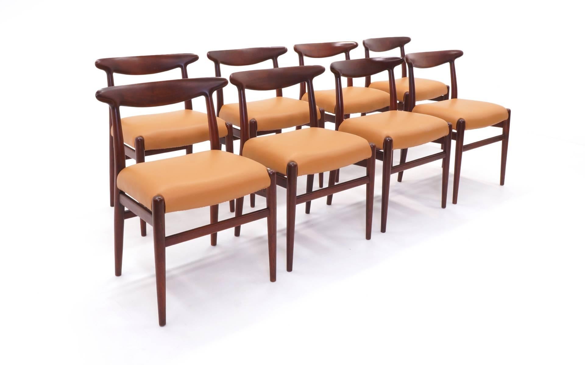 Set of eight Hans Wegner dining chairs, C.M. Madsens Fabriker, Denmark, 1953. Stained teak with new camel color leather. Signed with partial stamped manufacturer's mark to frame of each example: [C.M. Madsen Fabriker Haarby Danmark made in Denmark