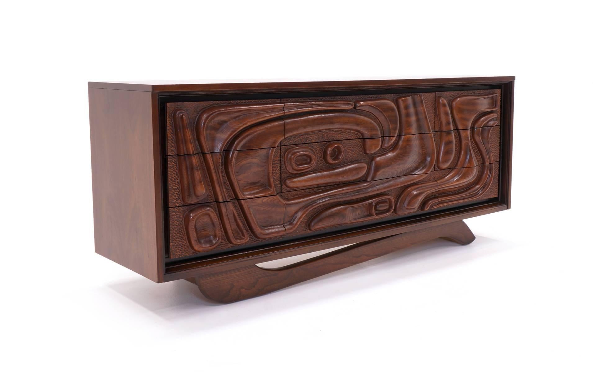 Unique organic shapes are sculpted into the nine drawers of this striking walnut cabinet / credenza / dresser.  This design is by Pulaski Furniture Corporation.   By the way, this is the exact same designed cabinet that was in Don Draper's office in