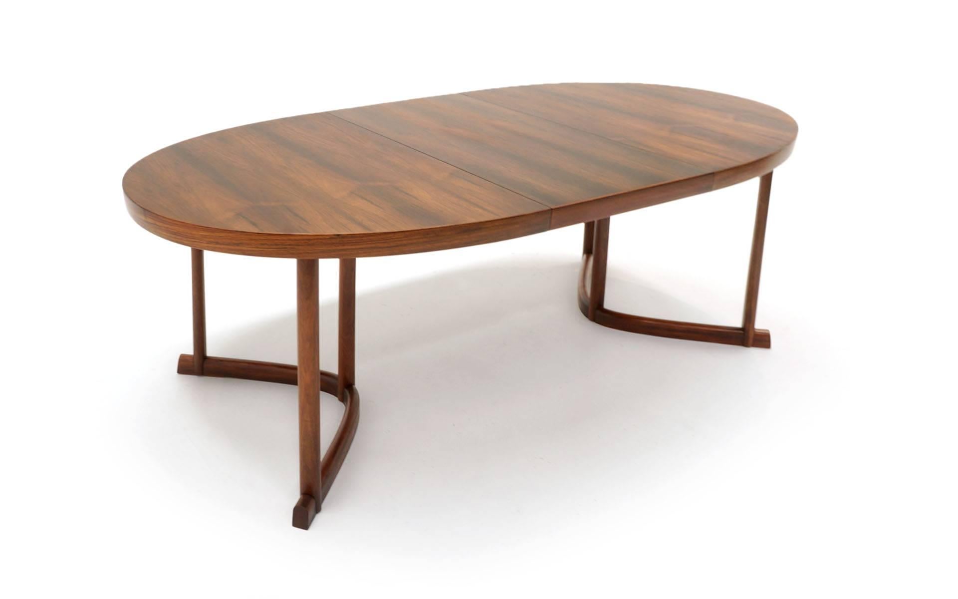 Beautiful Brazilian rosewood dining table made in Denmark, 1960s. 5 feet 4 inches long and expands to 7 (seven) feet with the 20