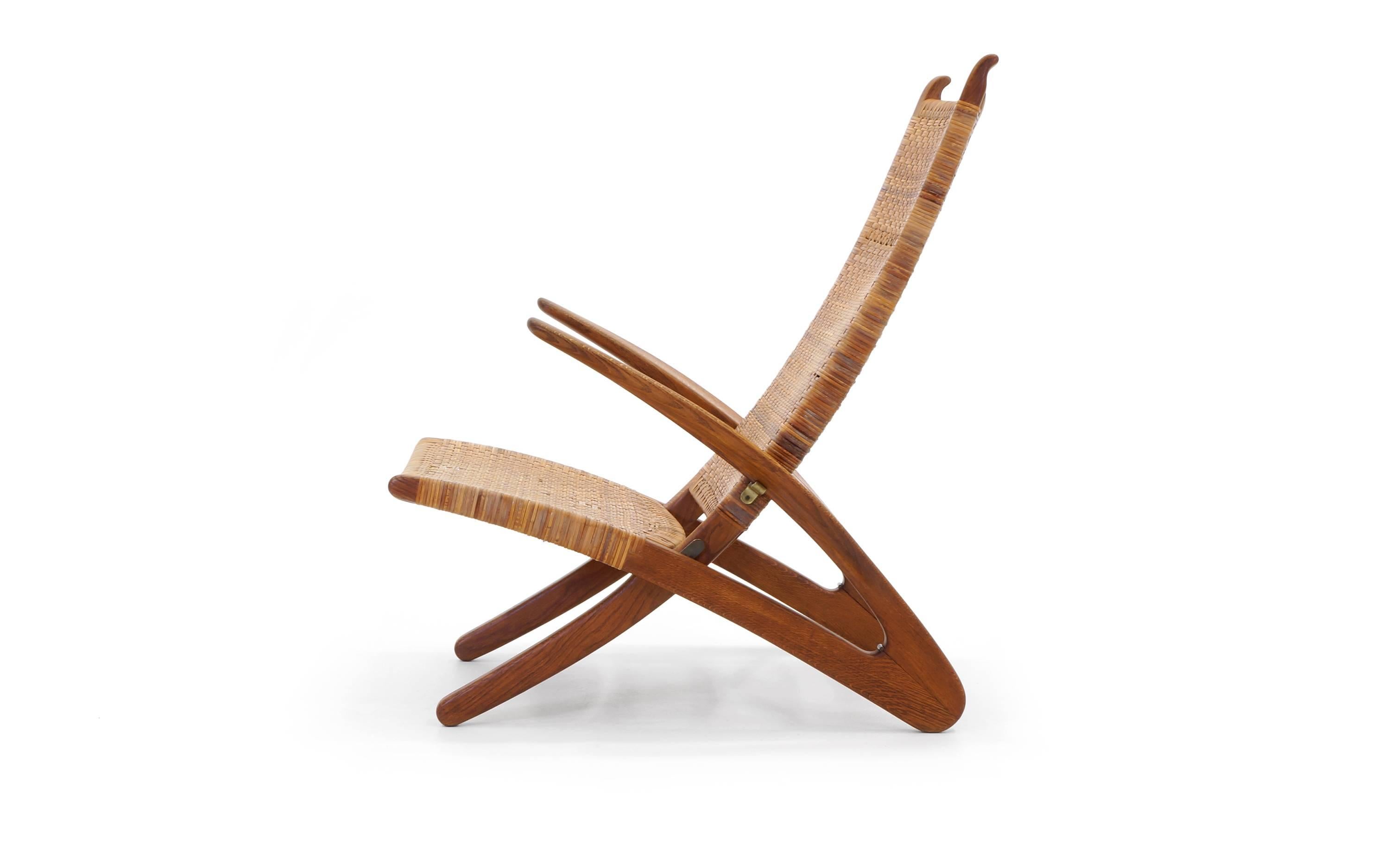 Extremely rare and highly desirable Hans Wegner Dolphin chair. There are only a few known examples of this work as it was never put into production. Hand-carved white oak frame with brass fittings and handwoven cane. This example has had only one