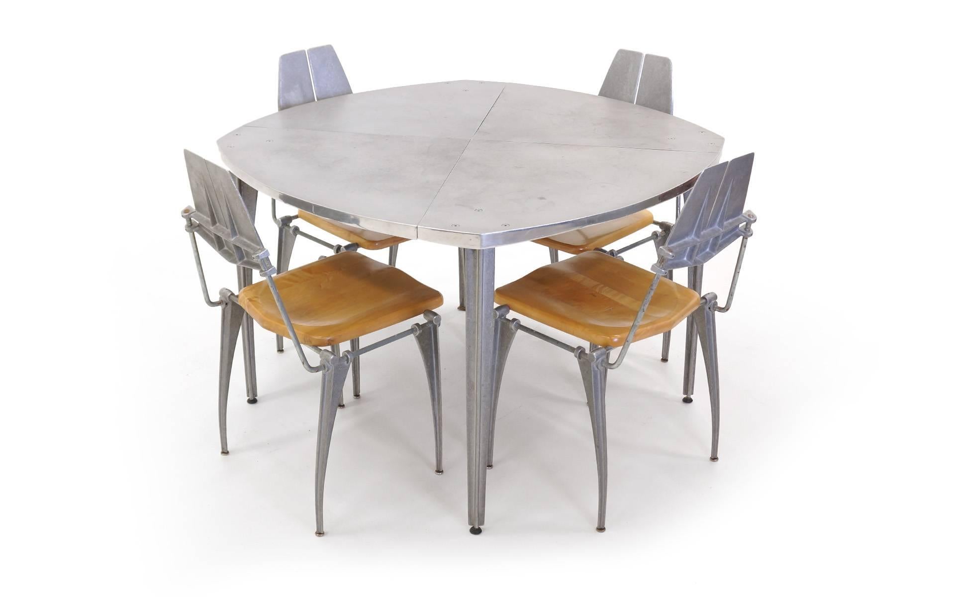 All original Robert Josten cast aluminum table and four chairs with cast aluminum frames and solid maple seats. The tabletop is the original cast aluminum in the form of a slightly rounded soft square, 1970s. Listing price is for the table and four