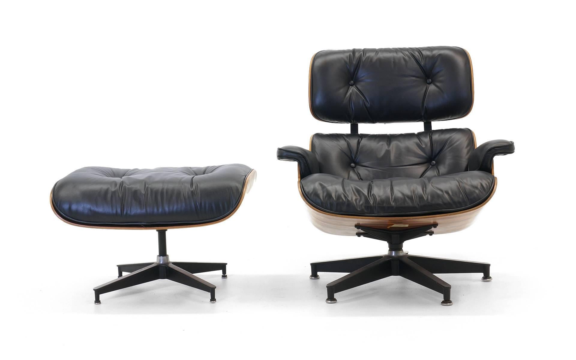 Superb example of the Classic rosewood lounge chair and ottoman designed in 1956 by Charles and Ray Eames and manufactured by Herman Miller. This example, from the 1970s, has beautifully figured grain patterns in the rosewood and the black leather