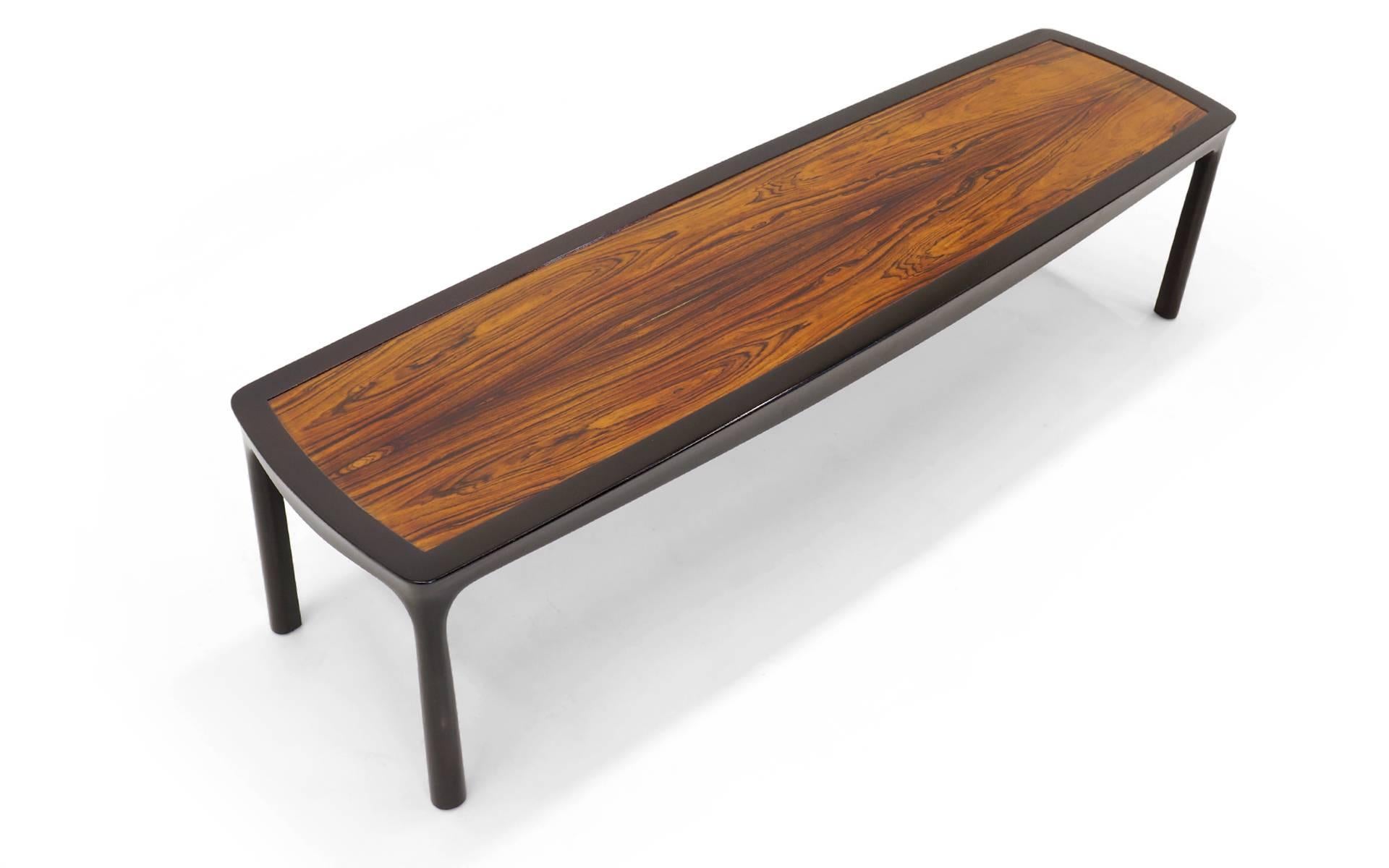 Edward Wormley coffee table with absolutely stunning figuring in the lightly bleached African mahogany top. The contours in the framework give a softness and richness to an otherwise rectangular design.