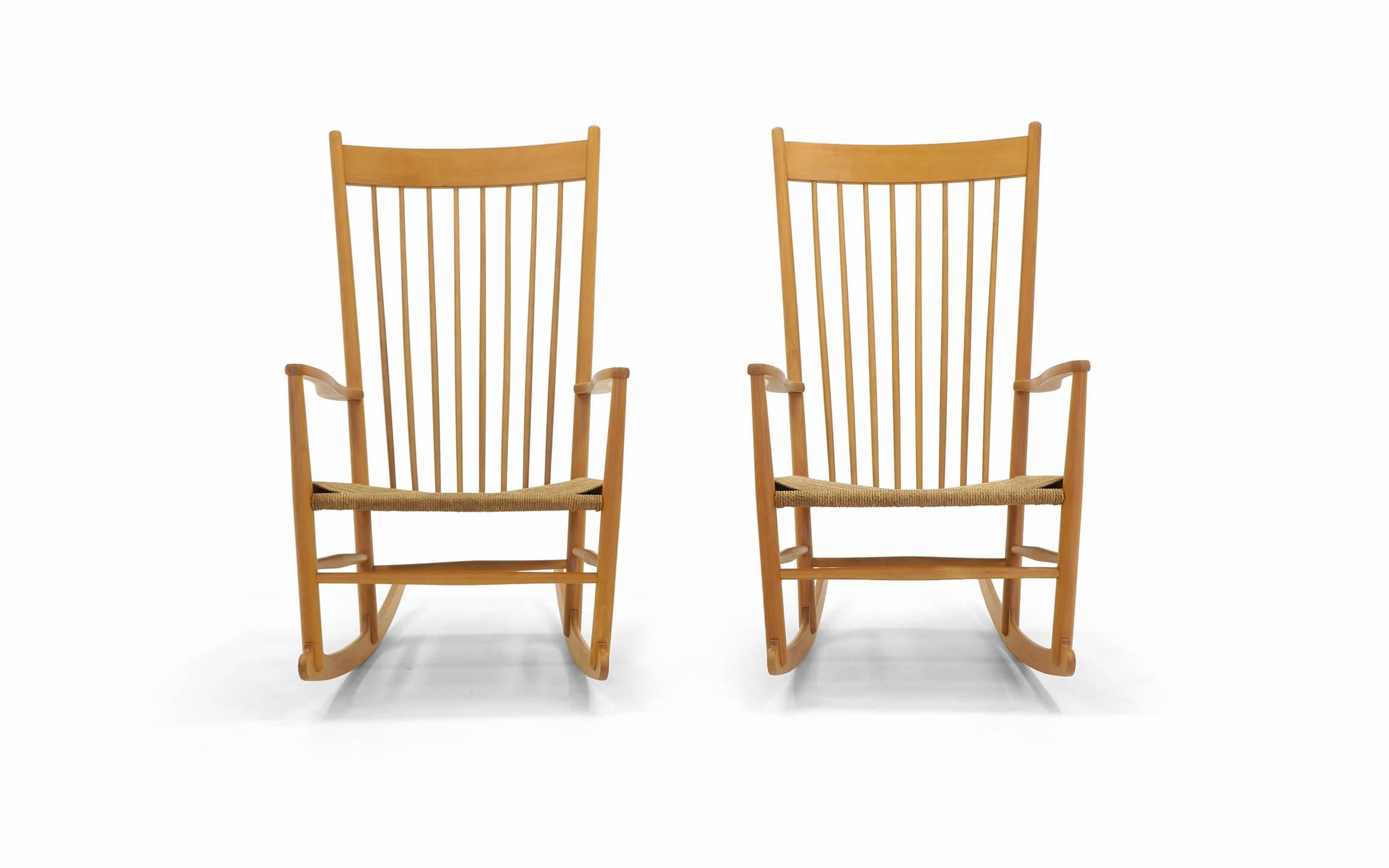 Excellent pair of J-16 rockers designed by Hans Wegner. These are earlier examples, all original. Overall dimensions are below. Additional dimensions: Chair seat is 18.5 inches deep and 22.5 inches wide.