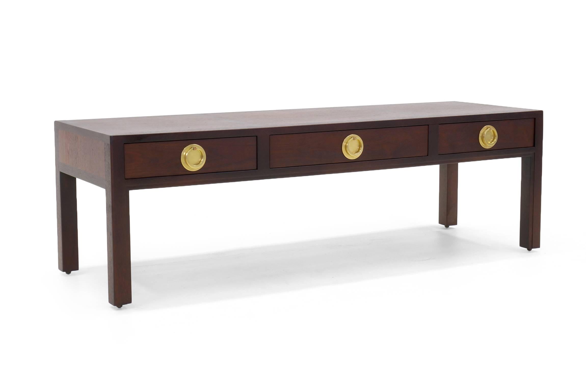 Elegant two-toned Edward Wormley coffee table with three drawers and solid brass pulls. Excellent condition.