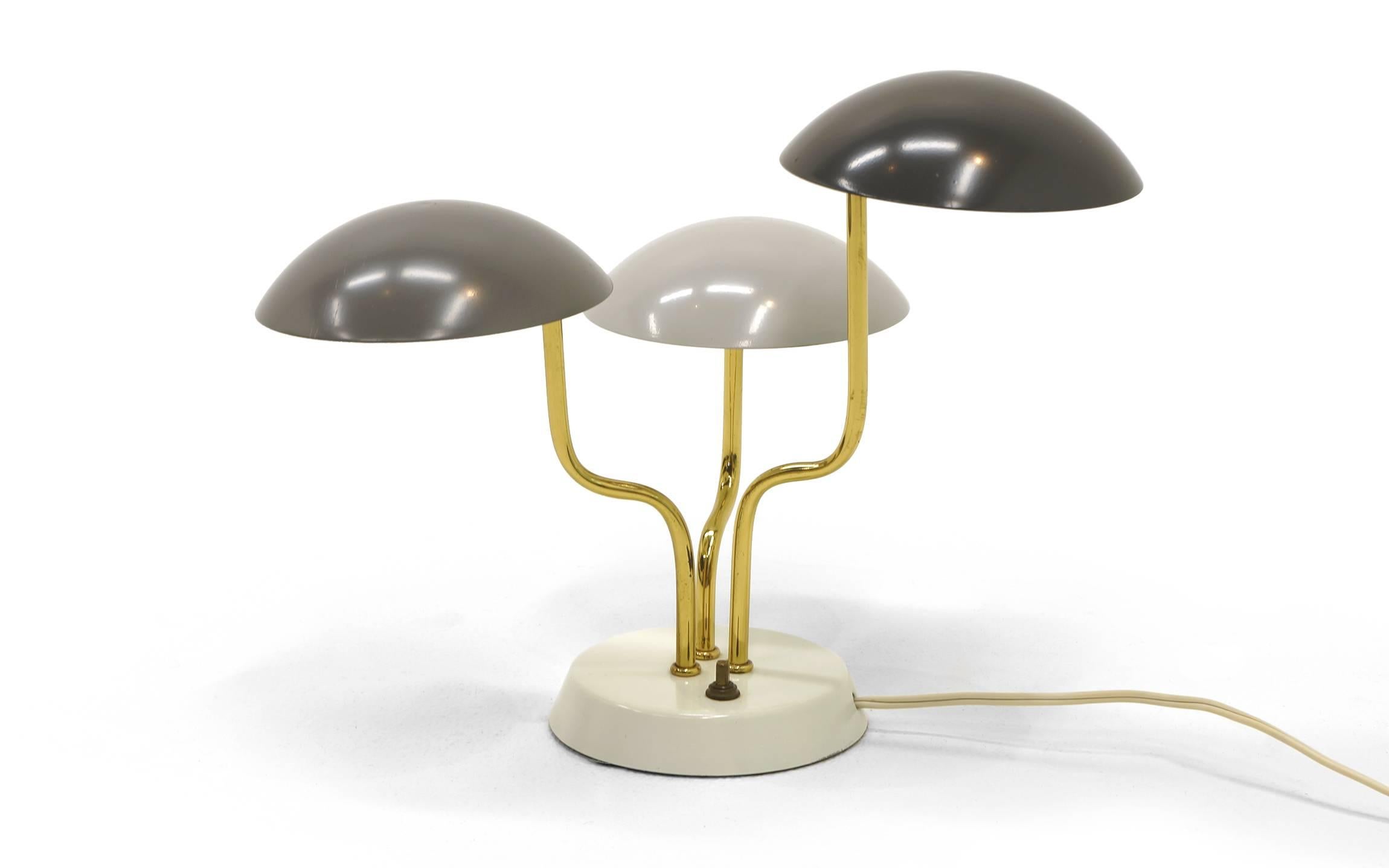 A stunning, small, Gino Sarfatti for Arteluce table lamp with curved brass rods rising from an ivory enameled base with three enameled shades in three shades of gray. Excellent original condition. Full lamp dimensions are below. Base diameter is 5