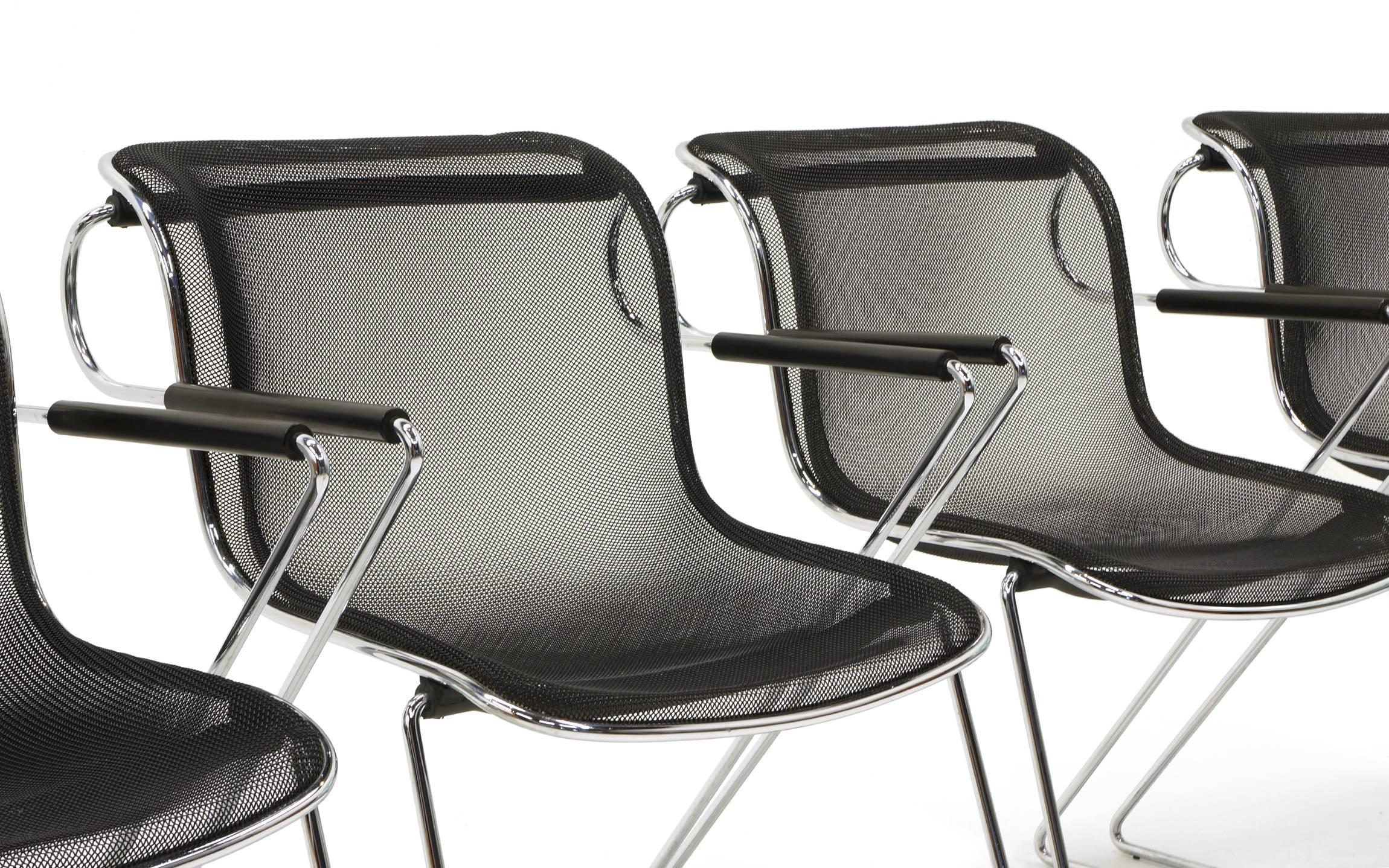 Charles Pollock (Pollack) for Castelli sturdy wire mesh and chromed steel stacking chairs with arms. We took each of these chairs apart and replaced the inner screws that break with age thus making them wobbly. If that has not been done on vintage