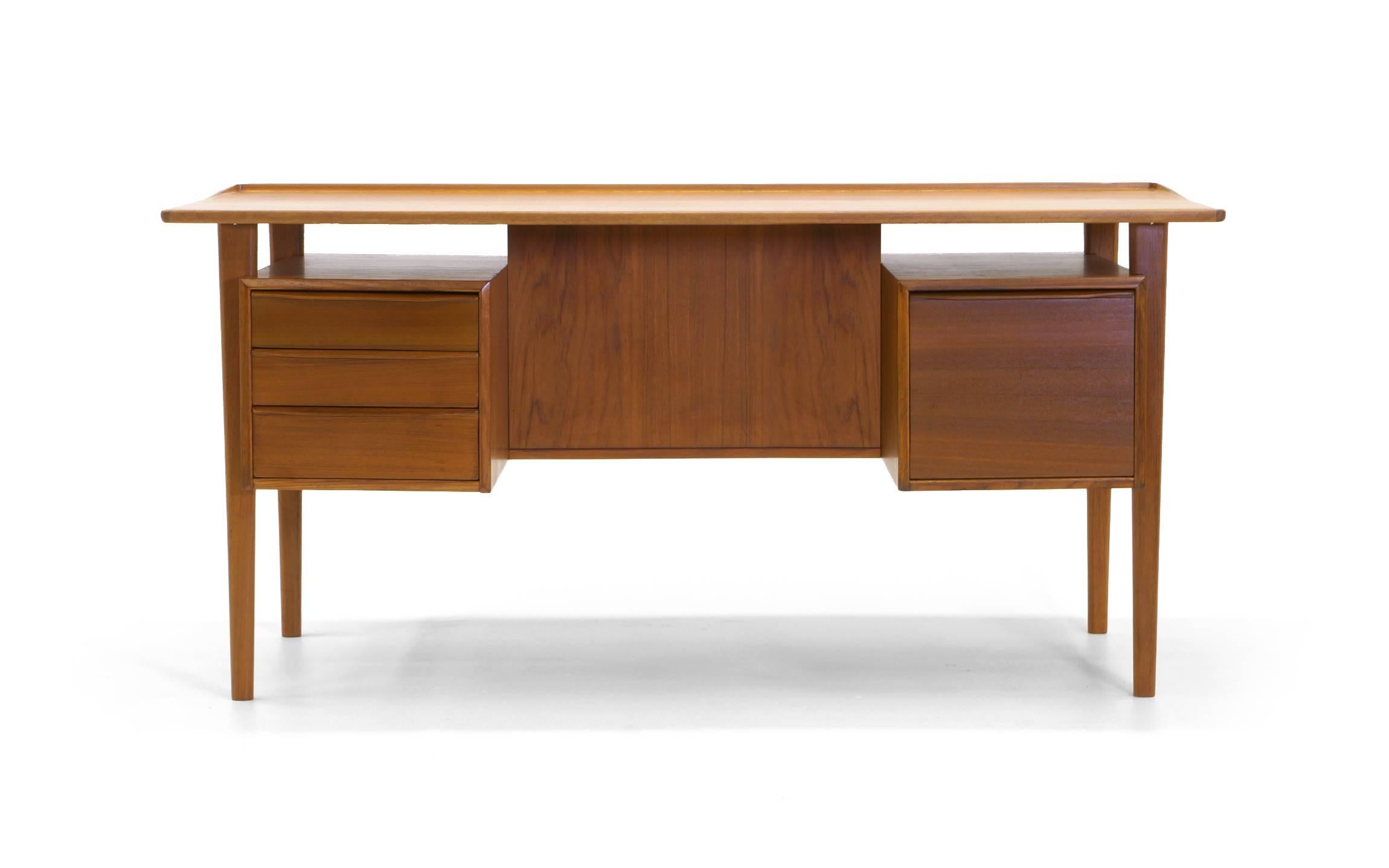 Teak desk by Peter Løvig Nielsen for Lovig. Expertly refinished Danish teak. Double pedestal drawers with storage. A beautiful mid-sized desk for home or office.