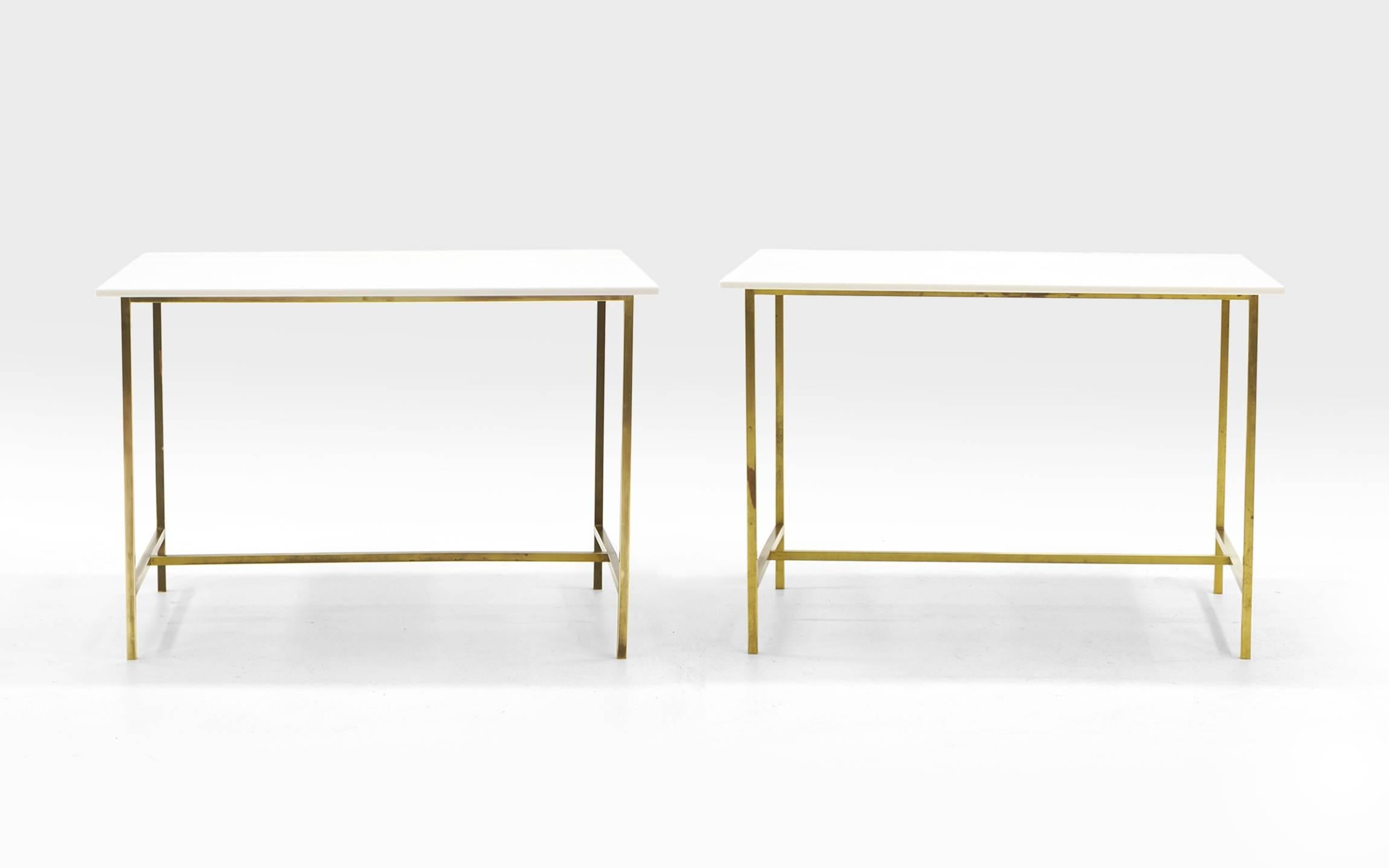 Elegant pair of Paul McCobb occasional tables. Solid brass tube frames with original white milk glass tops. Brass has attractive patina.