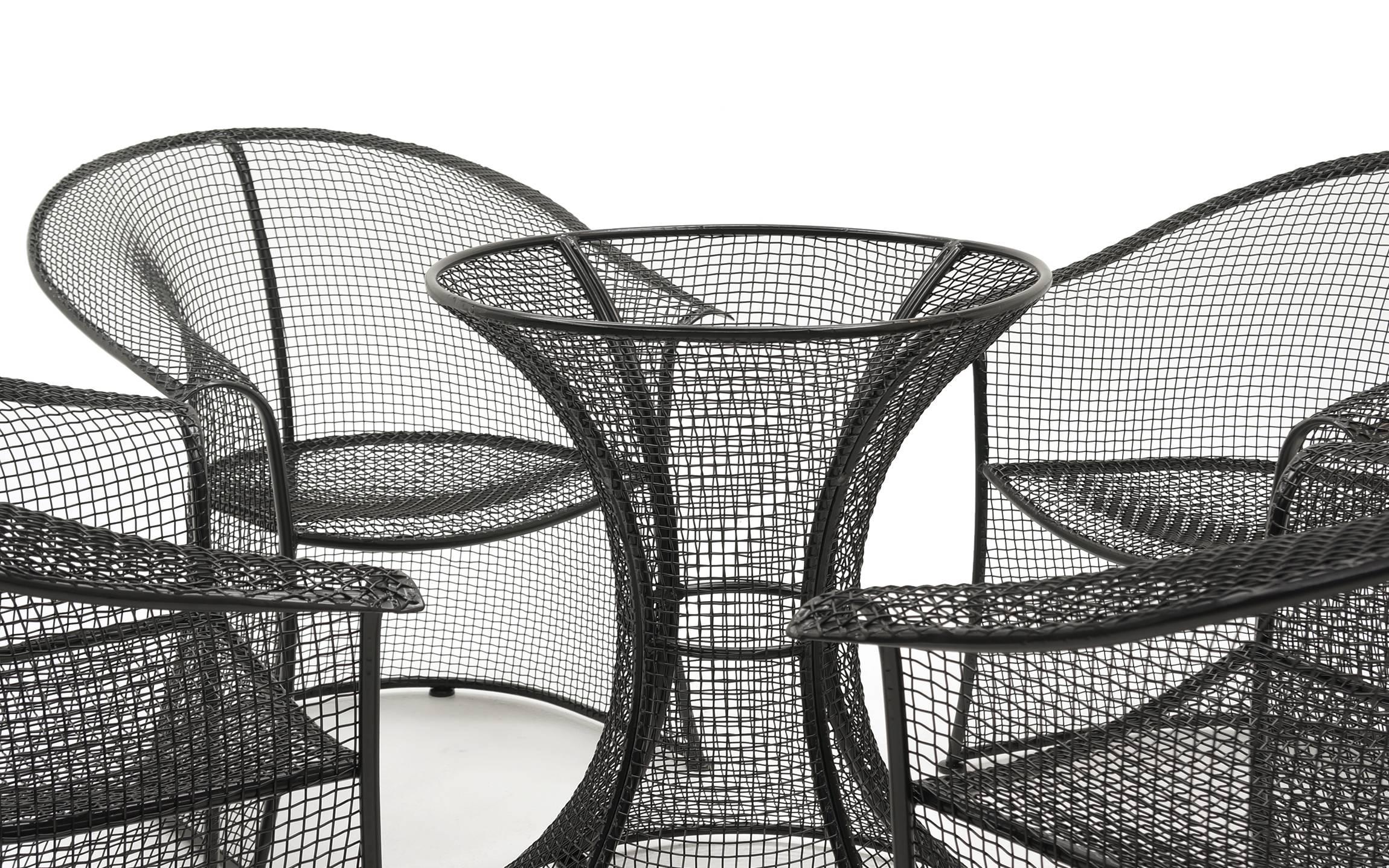 Rare sculptural Russel Woodard table and chairs for the patio or poolside. Woven wire construction like the Sculptura line, but this set is much more rare. Professionally powder coated in a satin black finish. Glass is not included. The base could