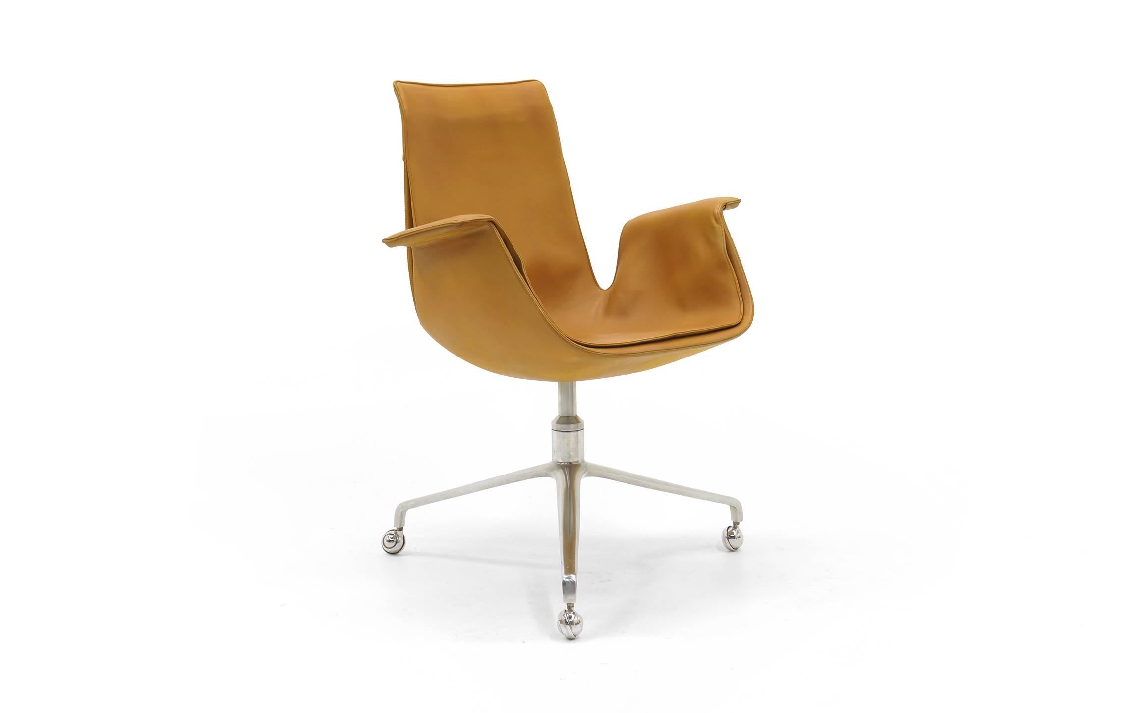 FK 6727 Tulip swivel chair designed by Preben Fabricius and Jørgen Kastholm. Manufactured by Kill International. Original camel / tan leather. Beautiful three prong base. Looks and functions great. 

.