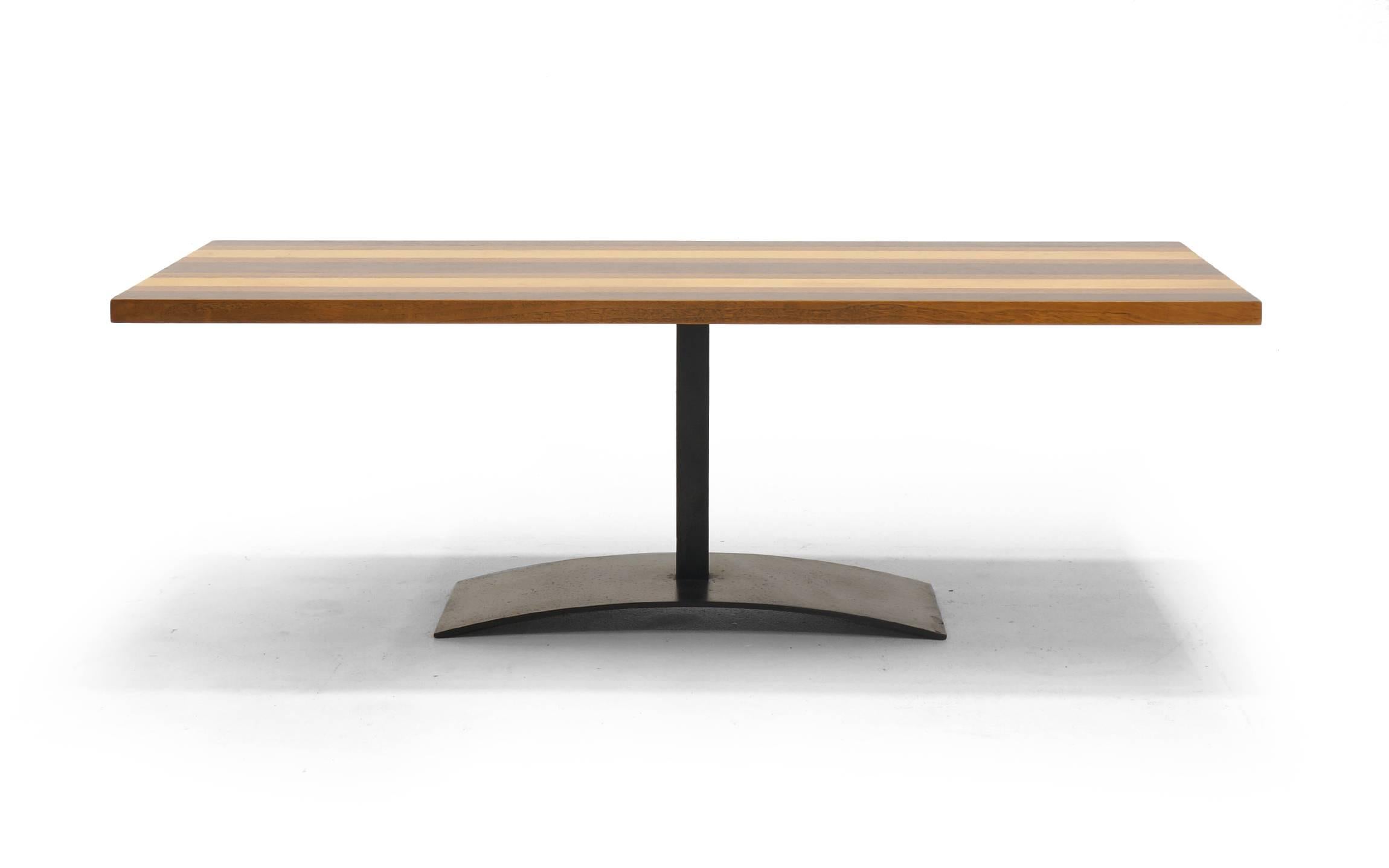 Milo Baughman coffee or cocktail table in a stunning mix of rosewood, walnut and oak. We have seen the dining table version of this design, but never the coffee table. Rectangular top with the original sculptural iron base.  Manufactured by