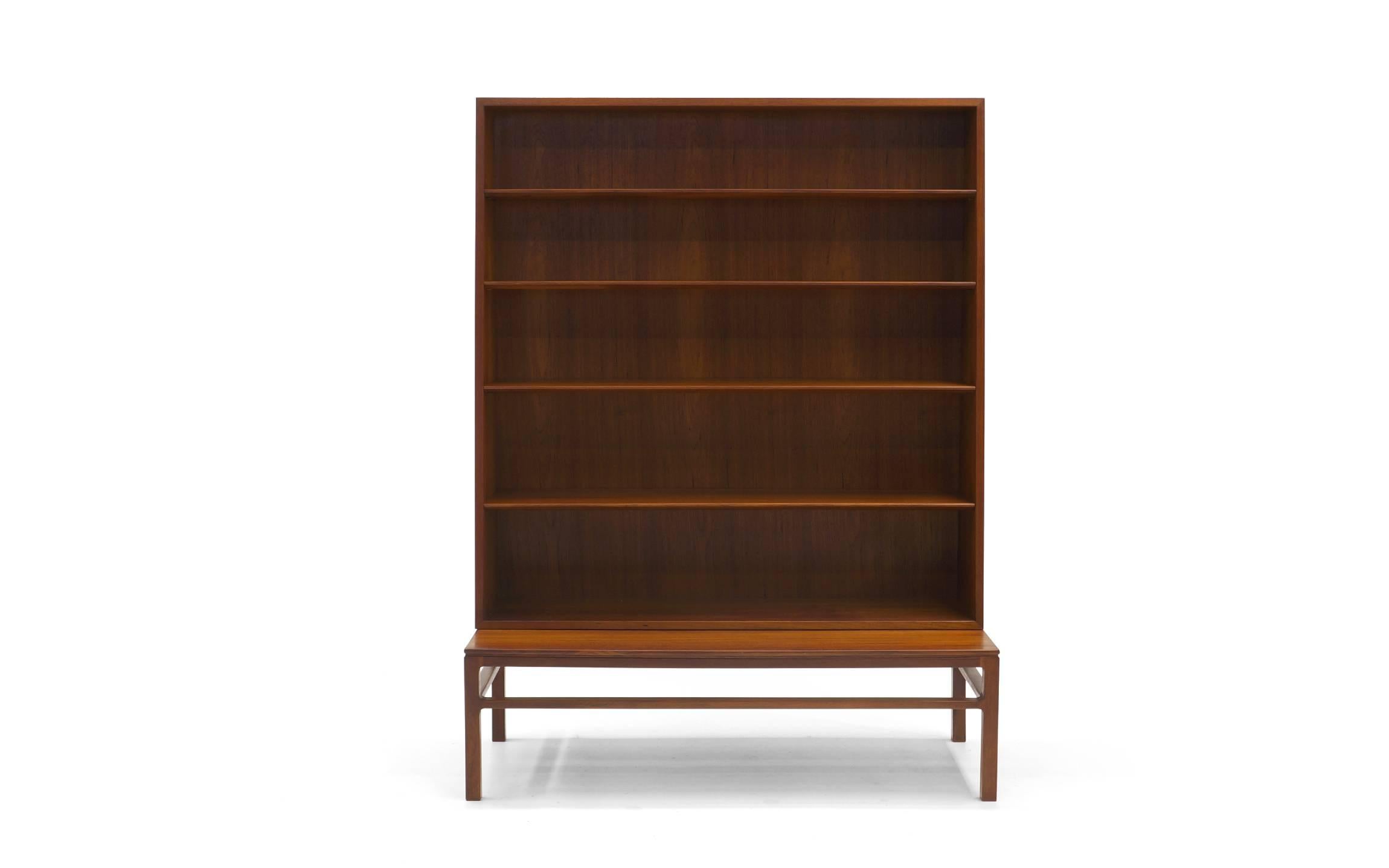 Hans Olsen rosewood bookcase. Two pieces for versatility and ease of moving. The book case tapers as it rises. Base/table height is 13.5 inches. Overall dimensions are below. Signed with Illums Bolighus metal tag.