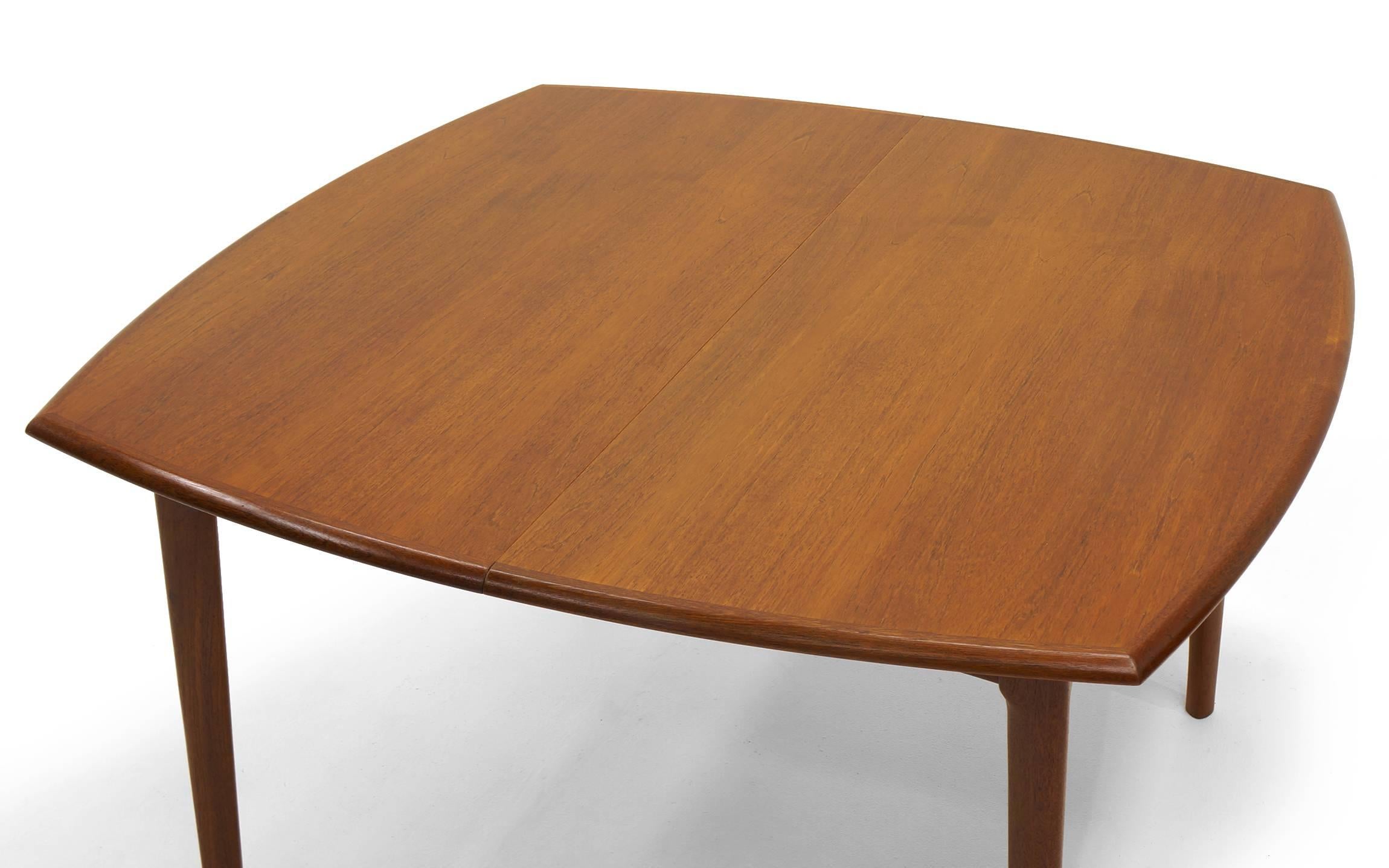 Expandable teak dining table designed by H. W. Klein for Bramin Mobler, Denmark. Starts at 47 inches square and expands to 76 inches and up to 105 inches when both of the 29 inch leaves are in place. Also a drop down center leg for added stability