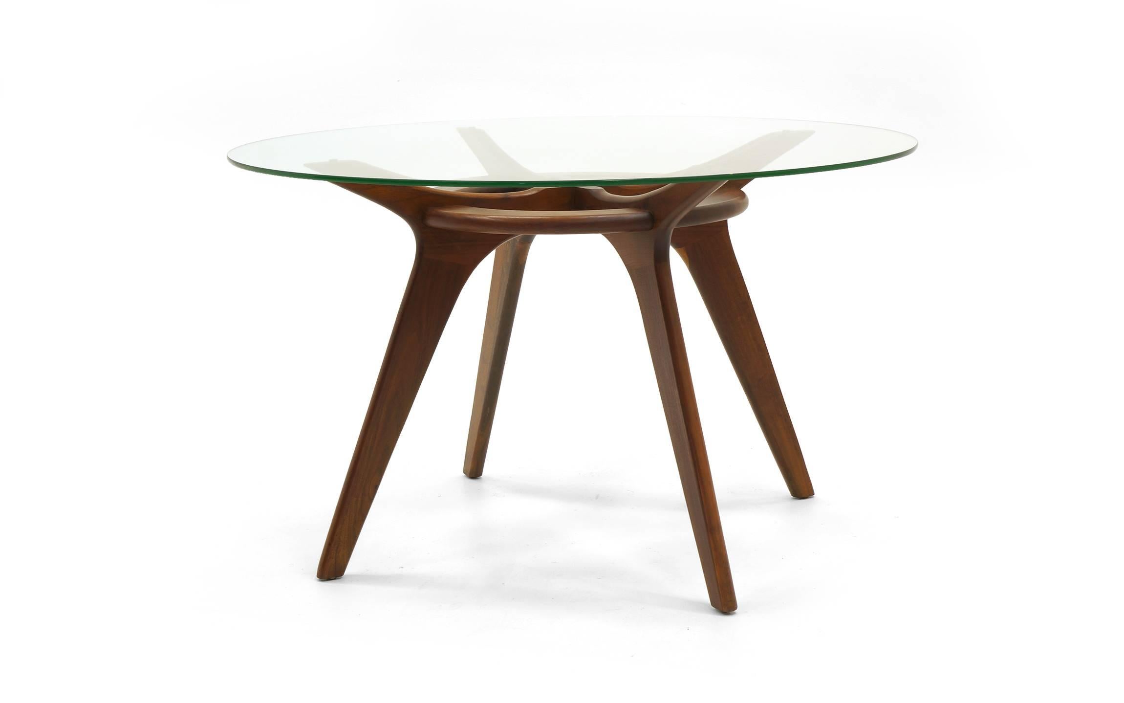 Adrian Pearsall round dining table. The original glass top is 48 inches in diameter and rests on a sculptural walnut base. A great example of this design in all original condition.