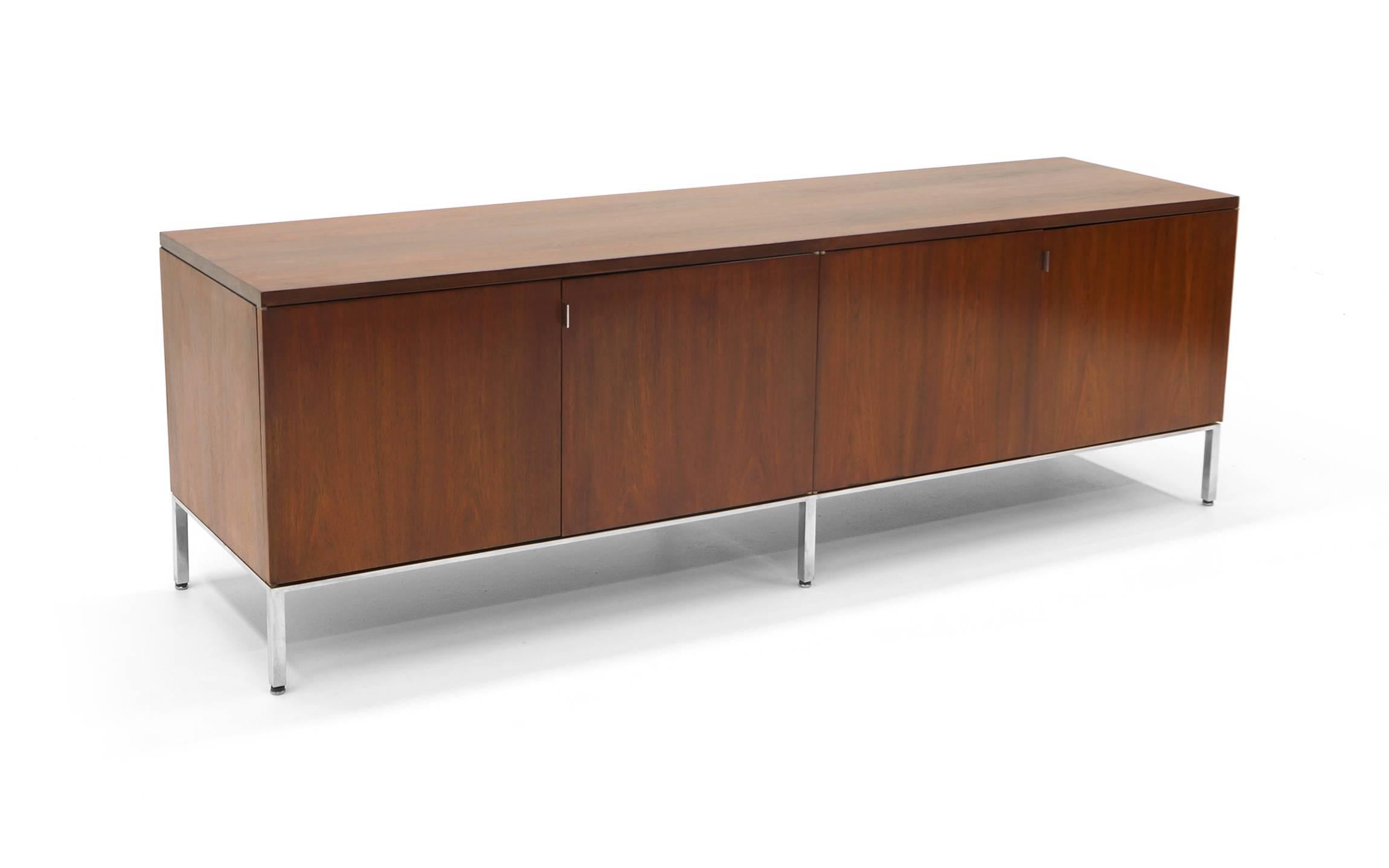 Florence Knoll for Knoll Brazilian Rosewood Credenza with polished chrome frame. Four doors reveal
 four sections with adjustable shelves making this great for general storage and perfect as a media cabinet and/or TV stand.
