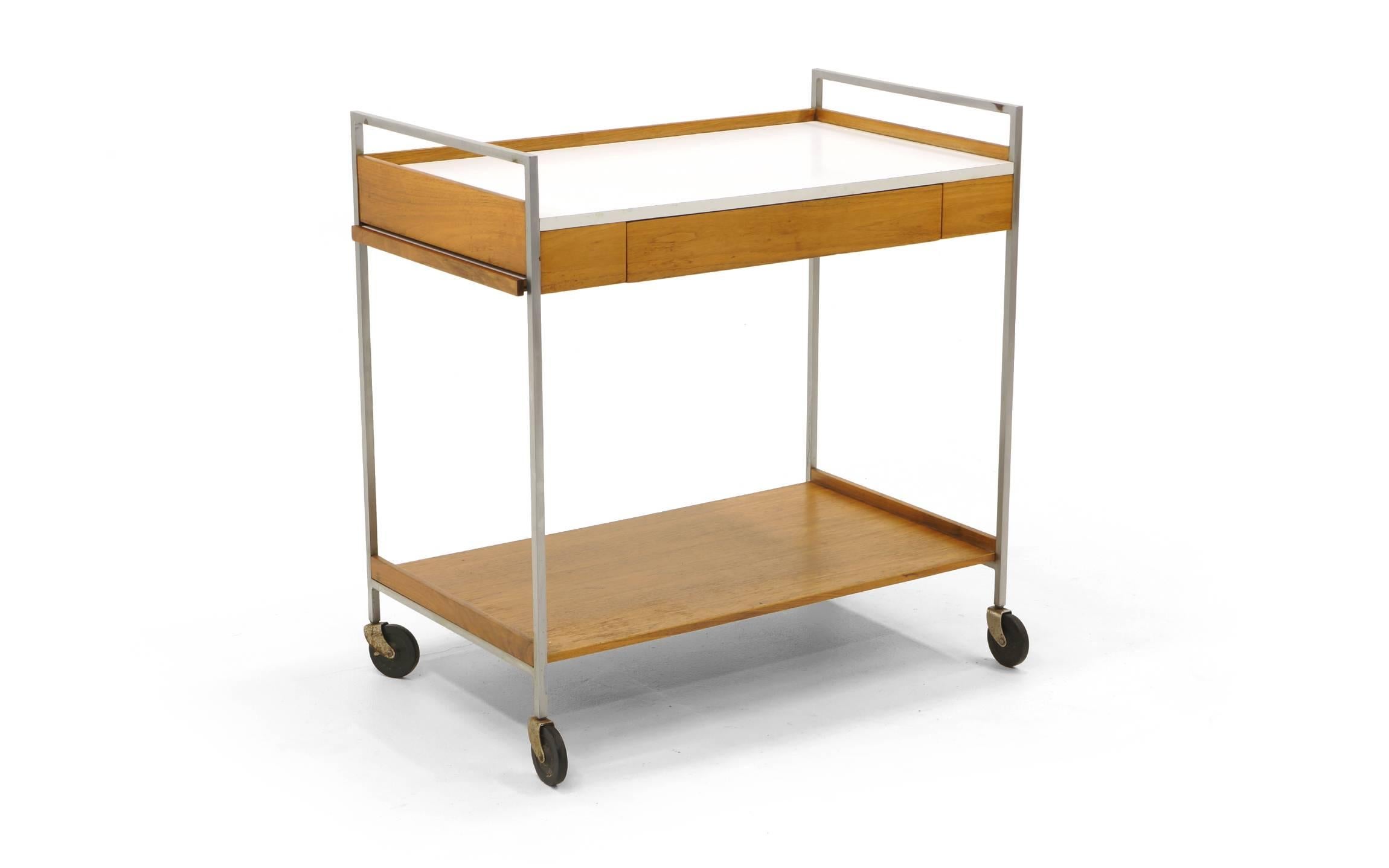 Rare George Nelson for Herman Miller serving cart on casters. Completely original. White laminate, walnut and brushed steel frame.