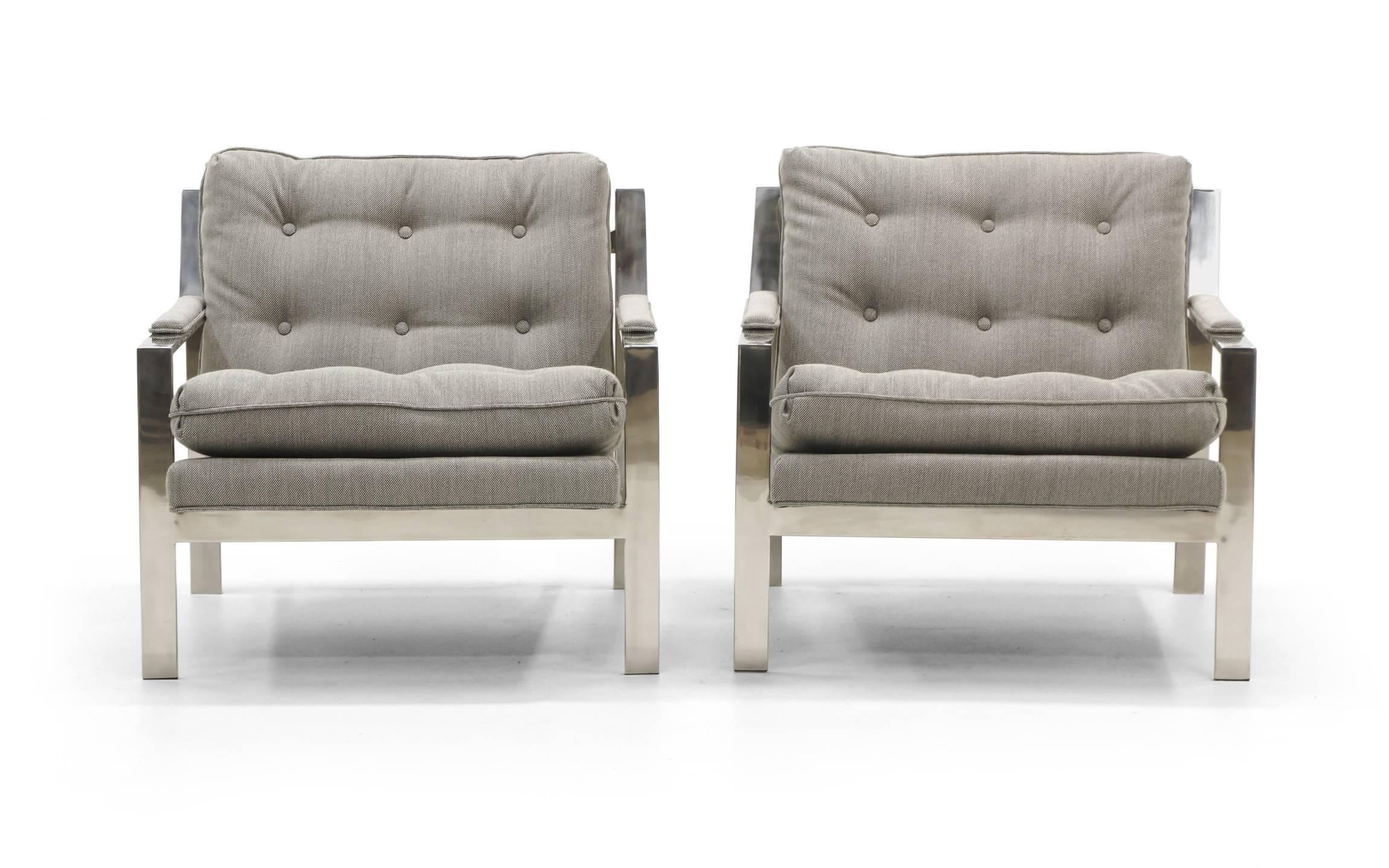 Pair of chrome framed lounge chairs designed by Cy Mann. These have been authentically and expertly restored and reupholstered in black and white Maharam Remix fabric with makes the chairs appear a light gray / grey. Also see our listing for a