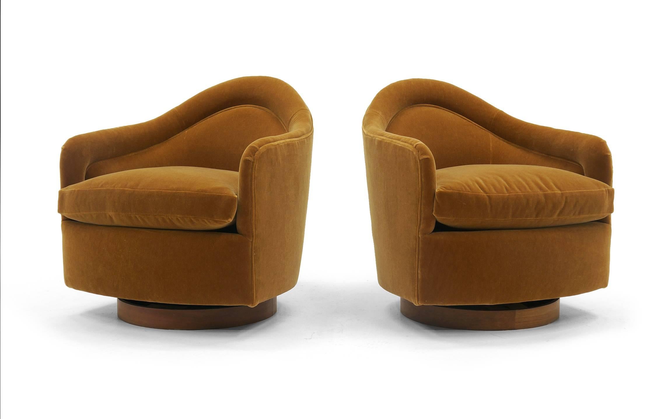 Pair of Milo Baughman tilt / swivel club / lounge chairs expertly restored and reupholstered in a beautiful $200 per yard camel / cognac color mohair fabric. Walnut base.