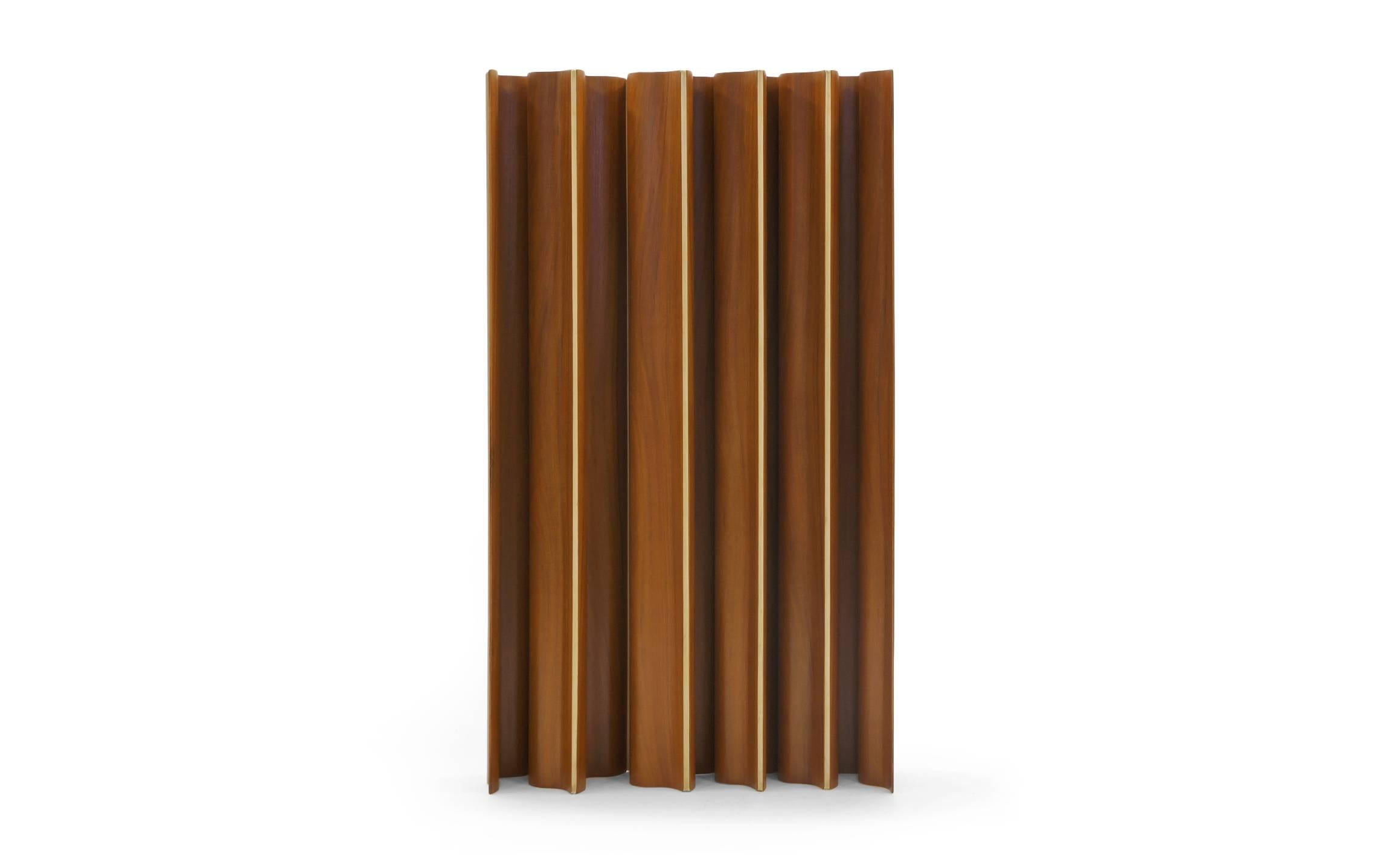 Molded plywood folding screen designed by Charles and Ray Eames, 1948. Eames folding screens were offered in six, eight and ten panel sizes. This rare and stunning example is made of ten hinged panels in teak.