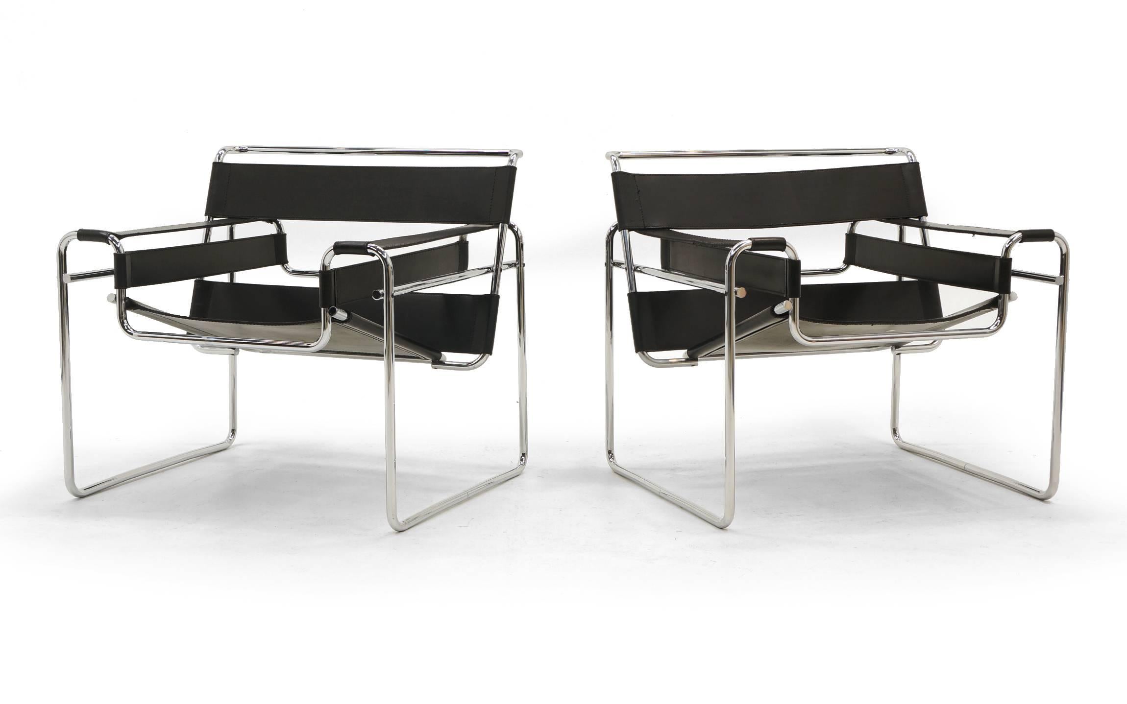 Early pair of authentic Wassily chairs designed by Marcel Breuer and made by Knoll. A true timeless Bauhaus design. One chair retains its early Knoll label. One chair shows what appears to be a very small repairs to a seam, other than that these are