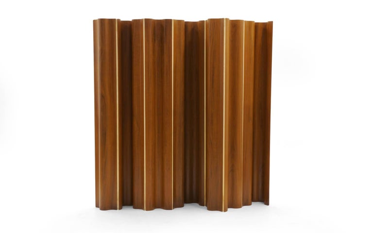 Molded plywood folding screen designed by Charles and Ray Eames, 1948.  Eames folding screens were offered in six, eight and ten-panel sizes. This is the very rare version made of ten hinged panels in teak. 